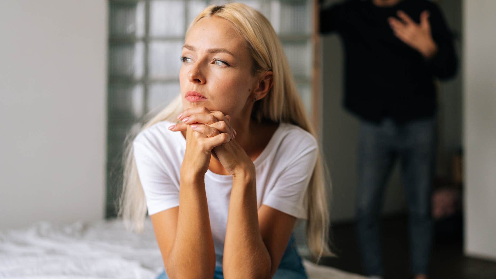 annoyed woman ignoring her partner in the doorway