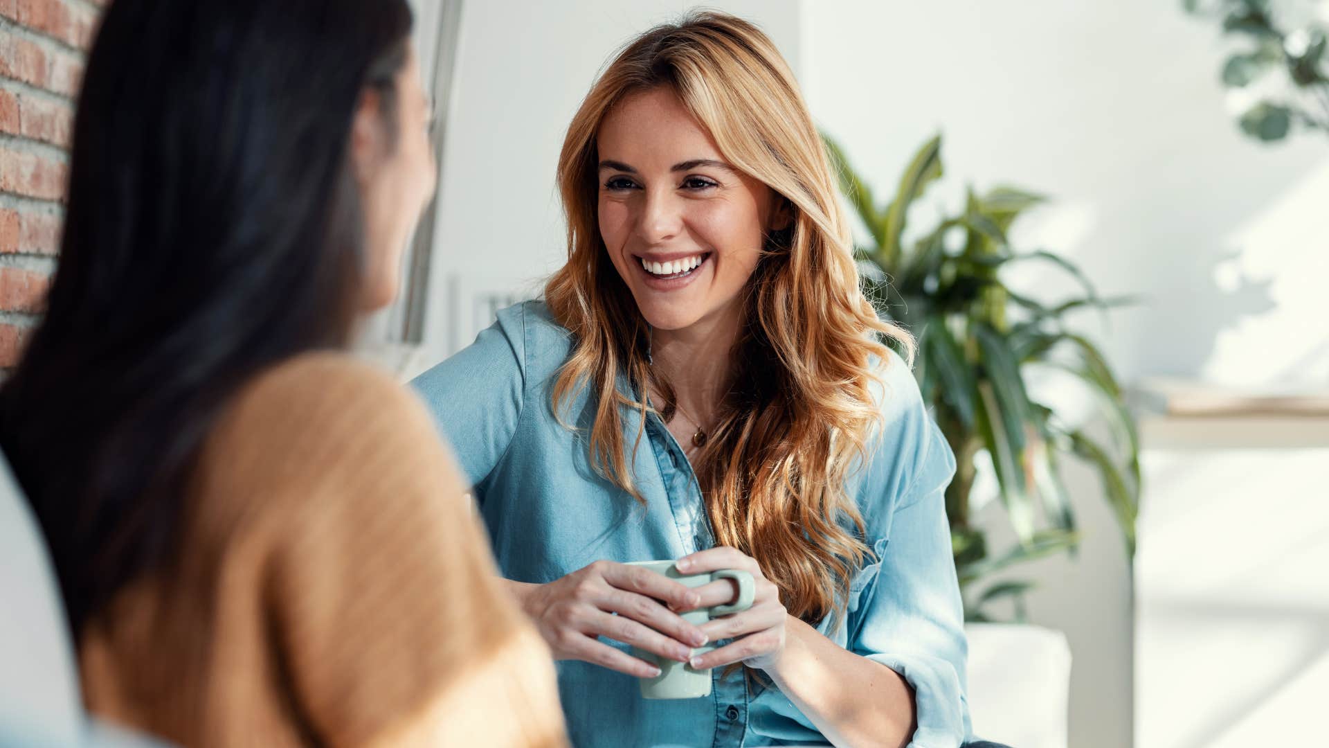 happy woman smiling and talking to a friend