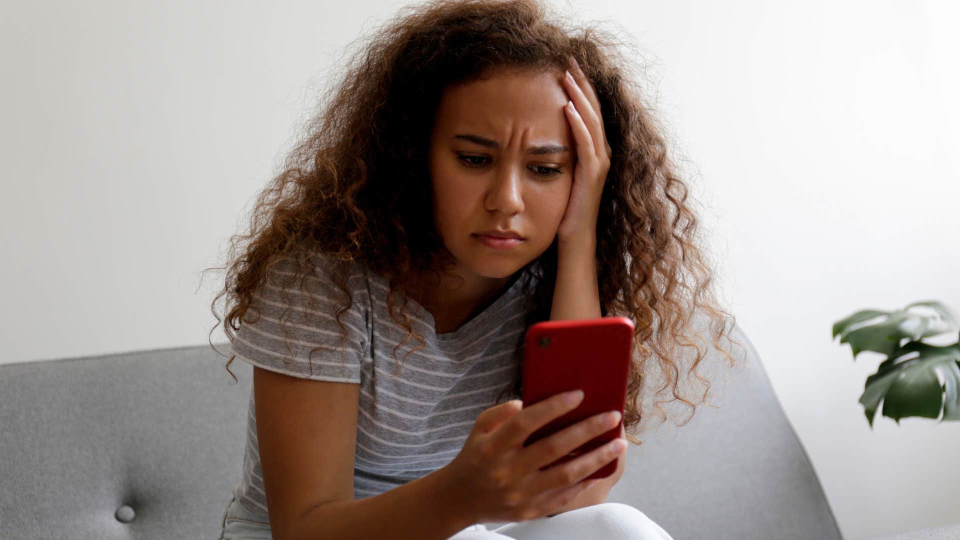 stressed woman doom scrolling on her phone