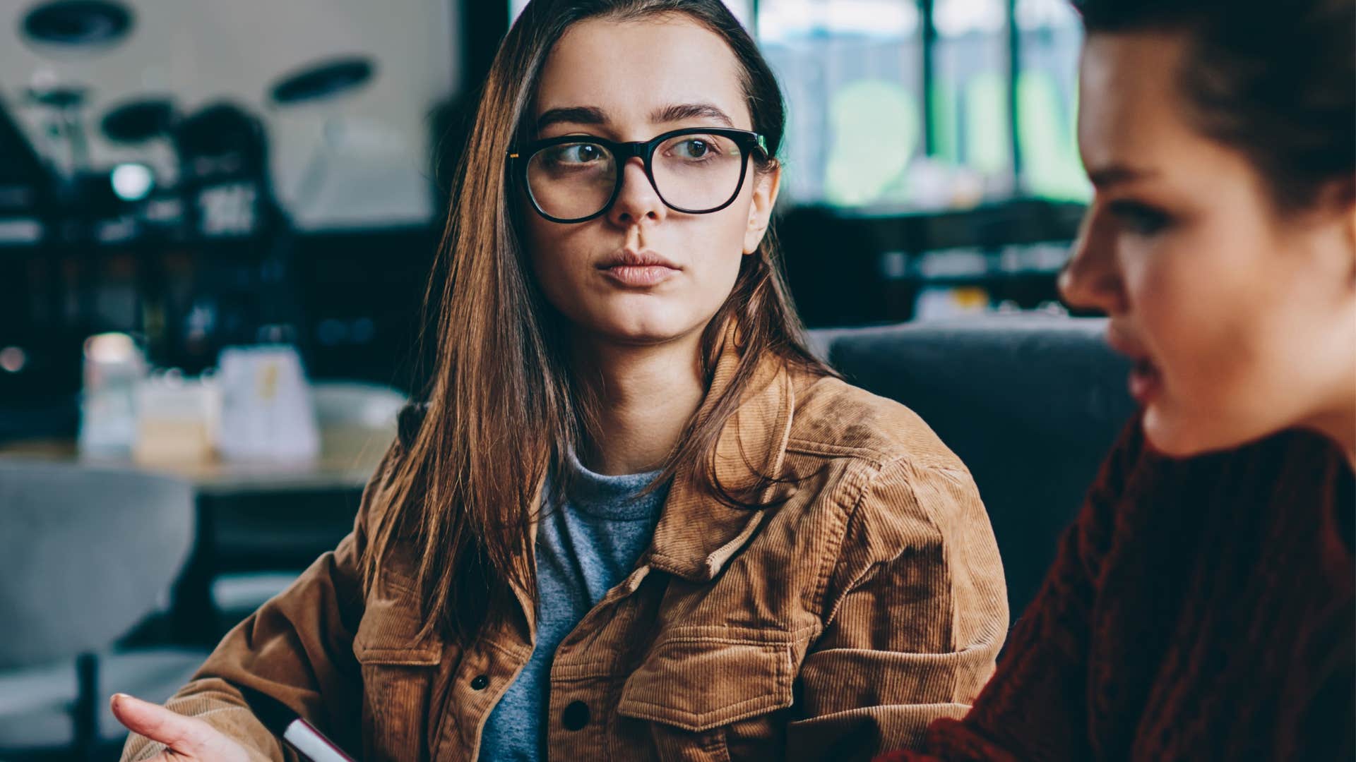 woman looking directly at avoidant friend