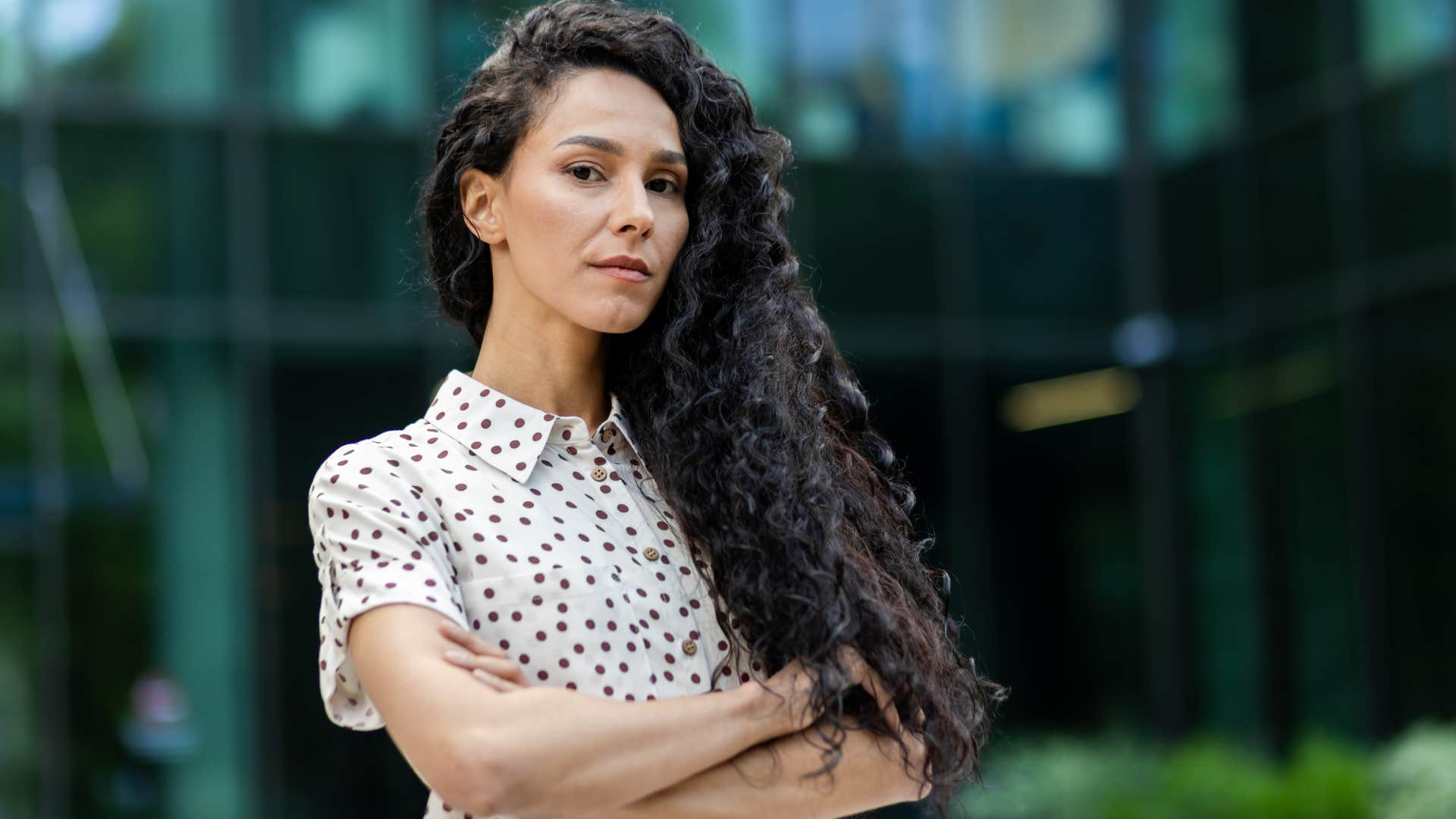 private woman standing outside with arms crossed