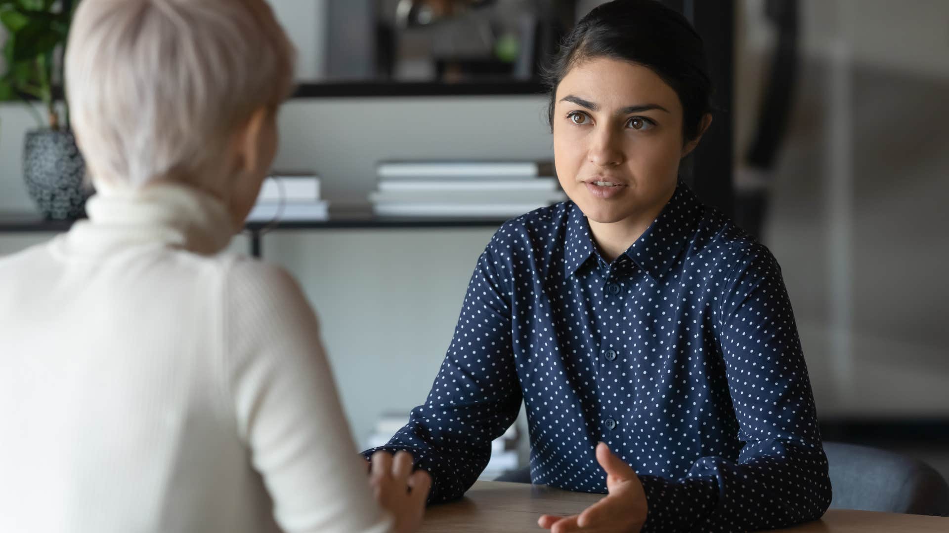 professional woman having a serious conversation with a peer