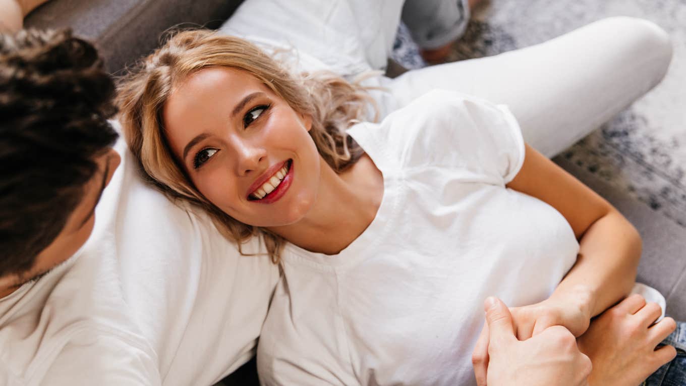 Blonde woman looking lovingly at a man while fixing relationship problem