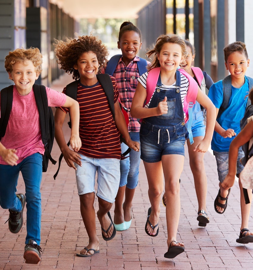 Group of children running and smiling