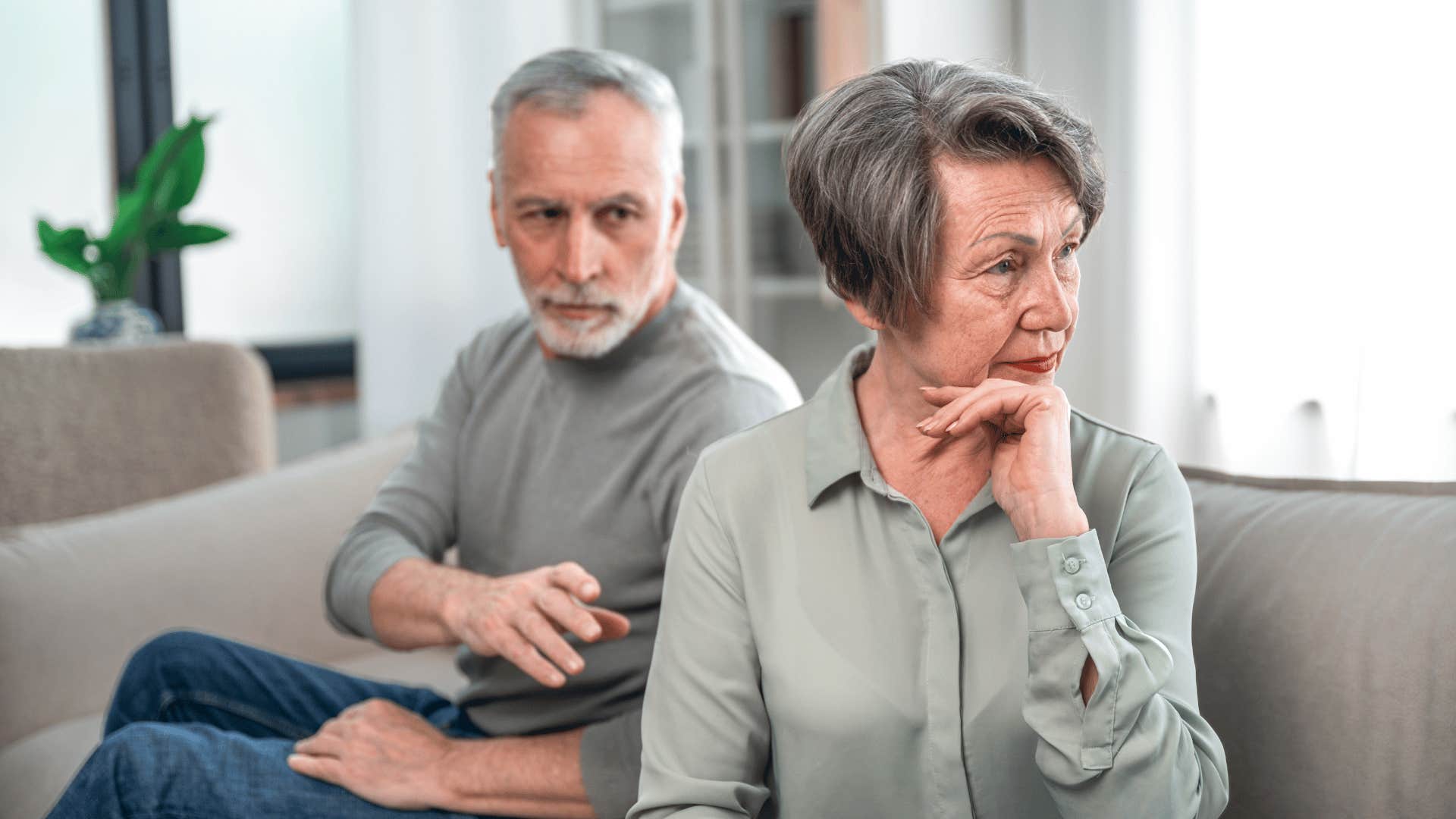 Defensive woman turns away from inquisitive man