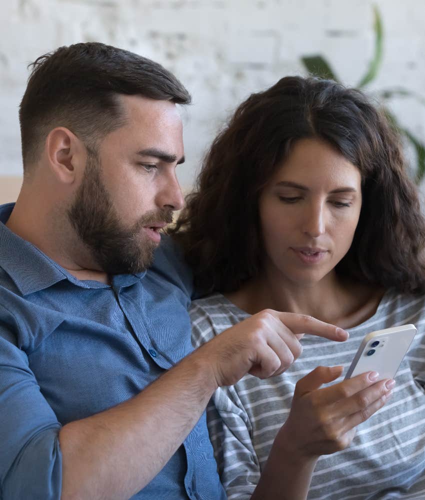 Couple looking at screenshot from 'Are We Dating The Same Guy' Facebook Group