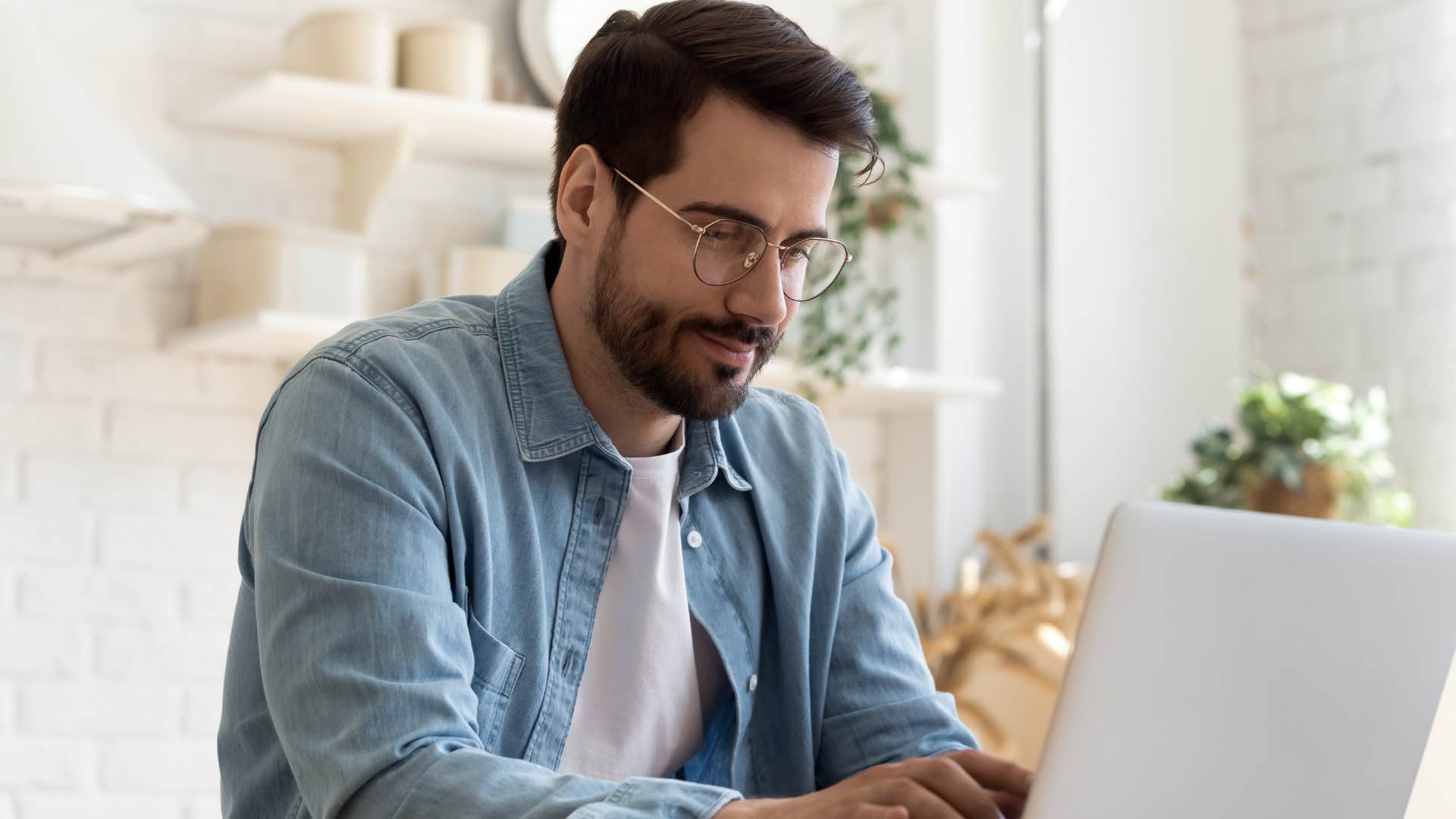 man working on laptop alone