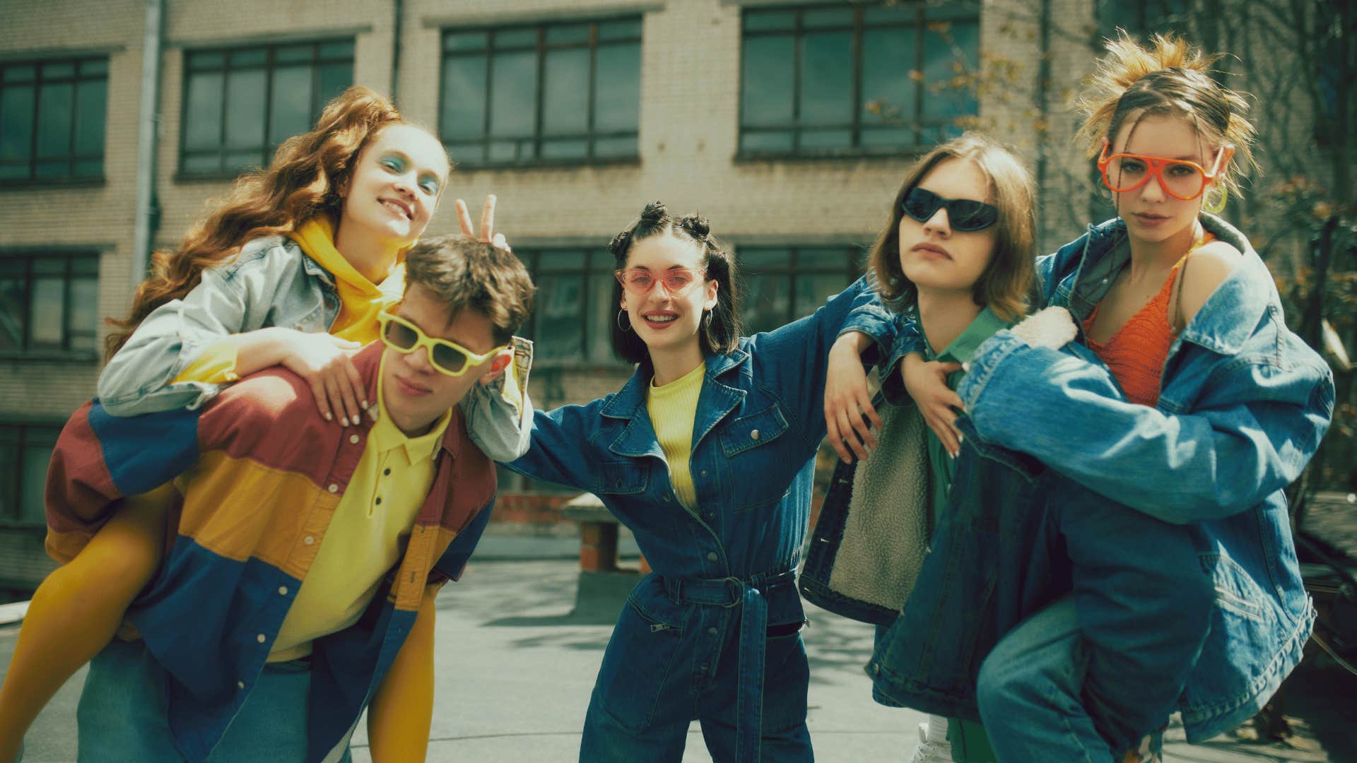 Cool group of retro looking young people pose together ourside