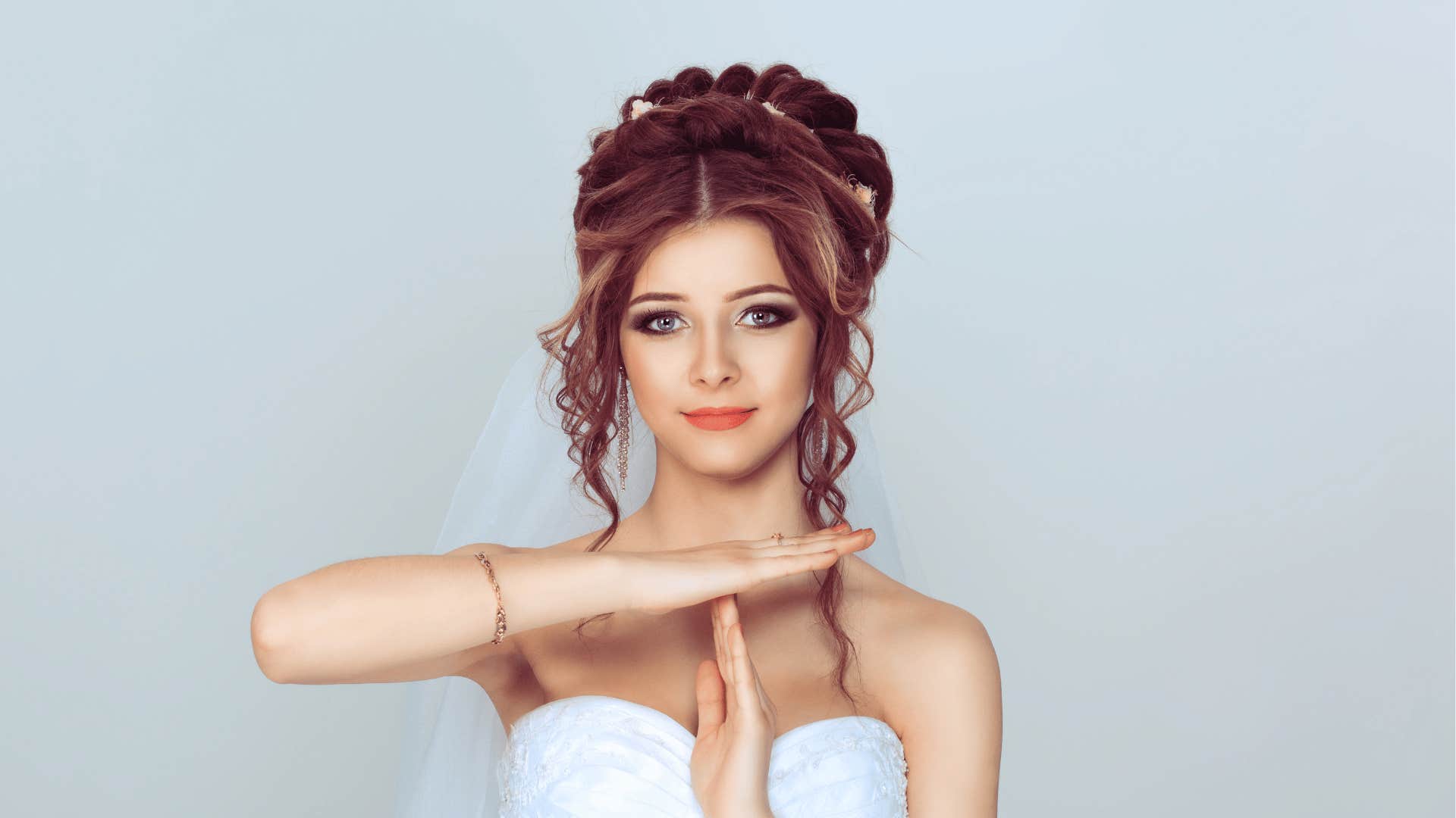 Bride in wedding dress gives time out hand signal