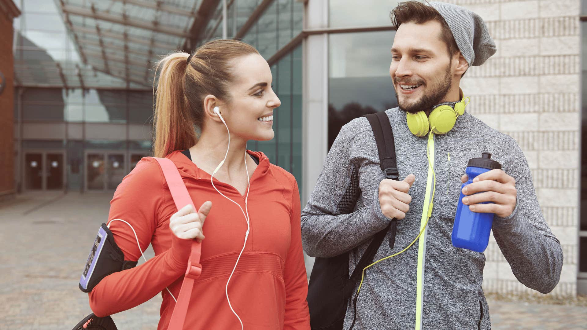 two young adults talking after working out