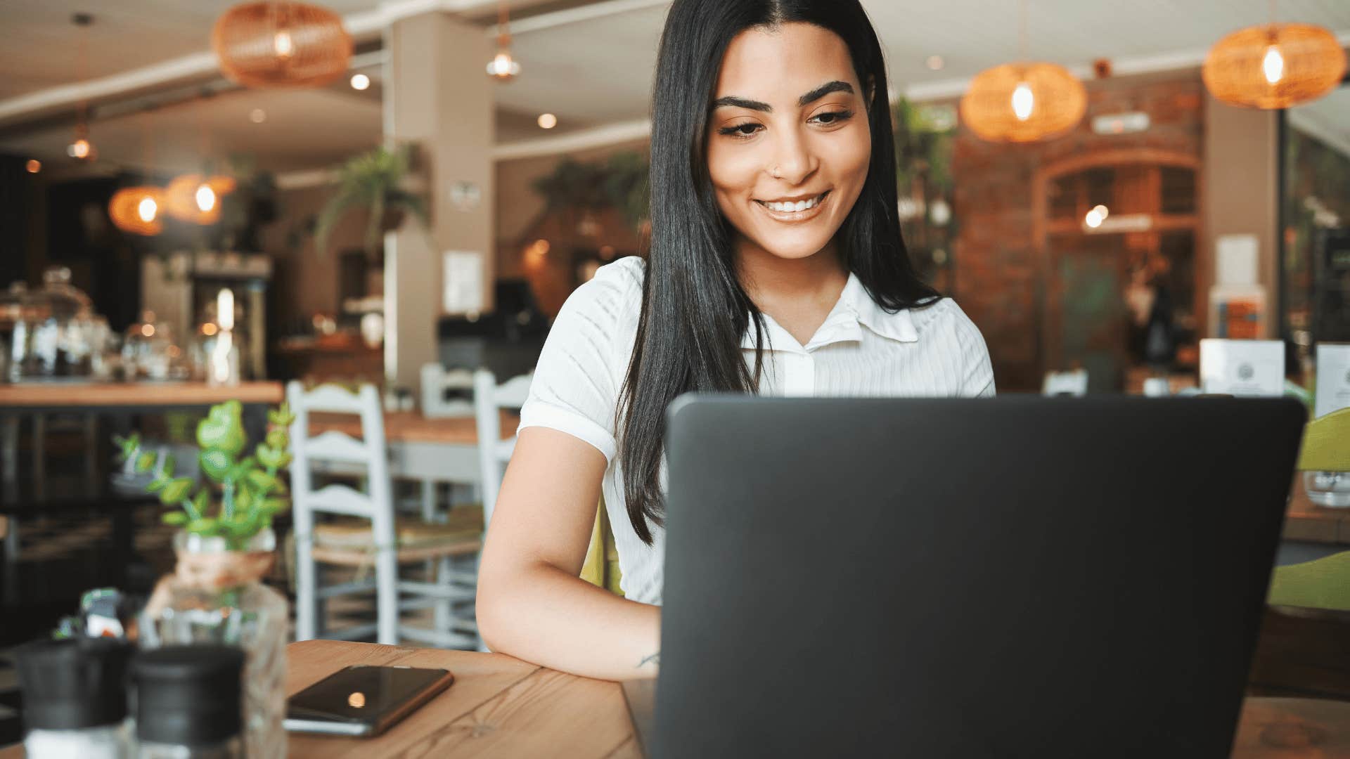 woman on laptop at cafe