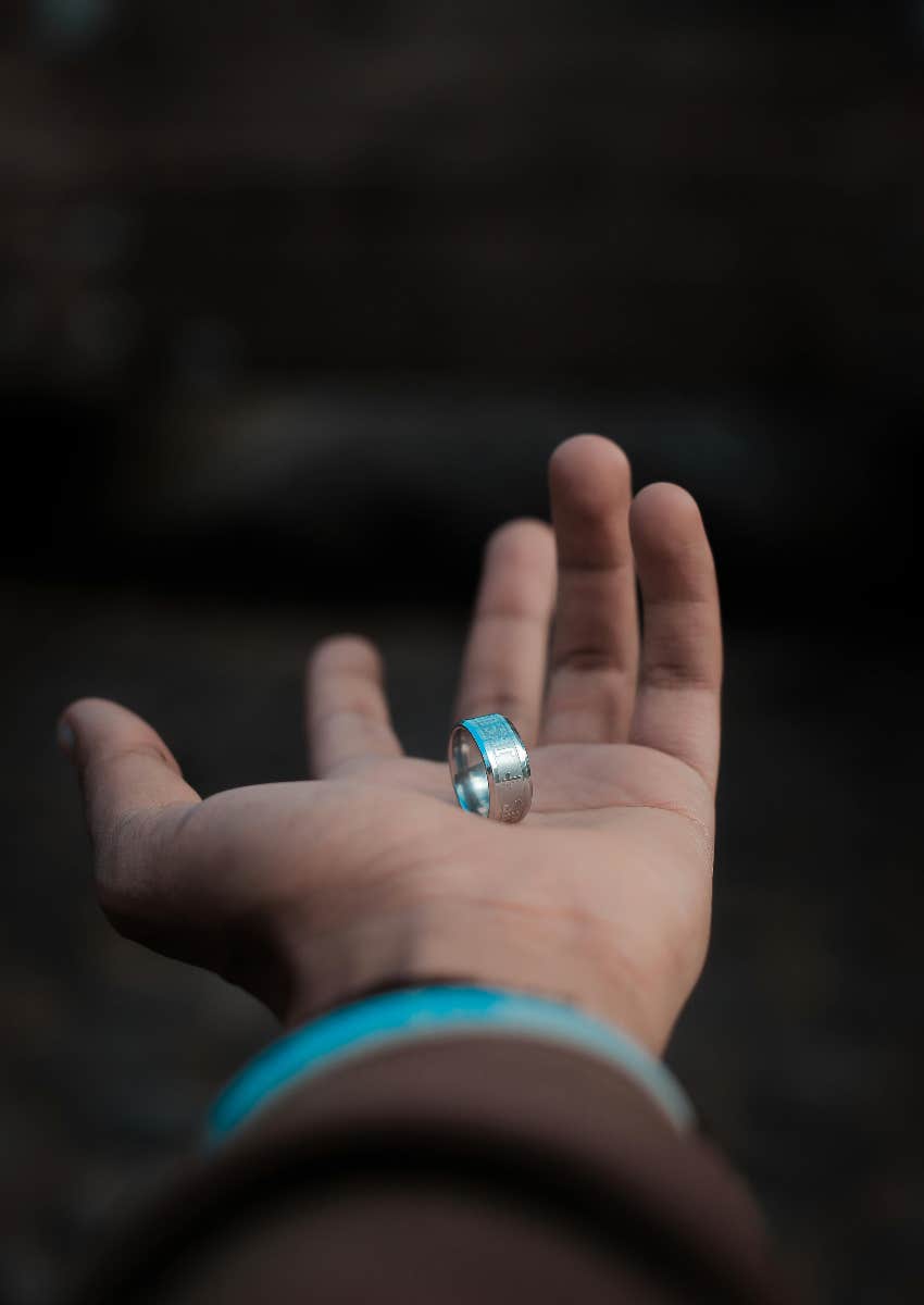 hand holding Oura Ring