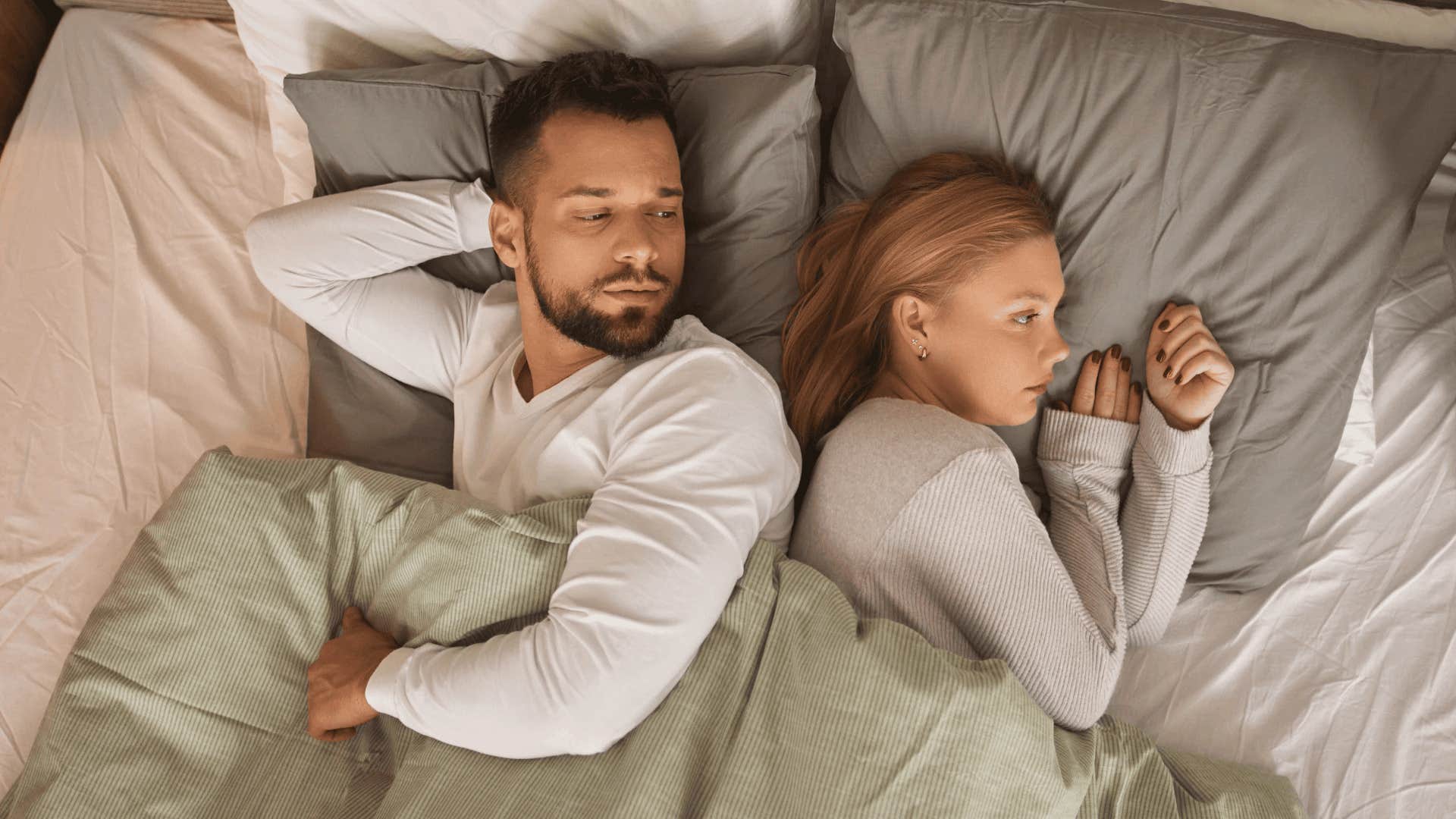 upset man lying next to woman who has no close relationships