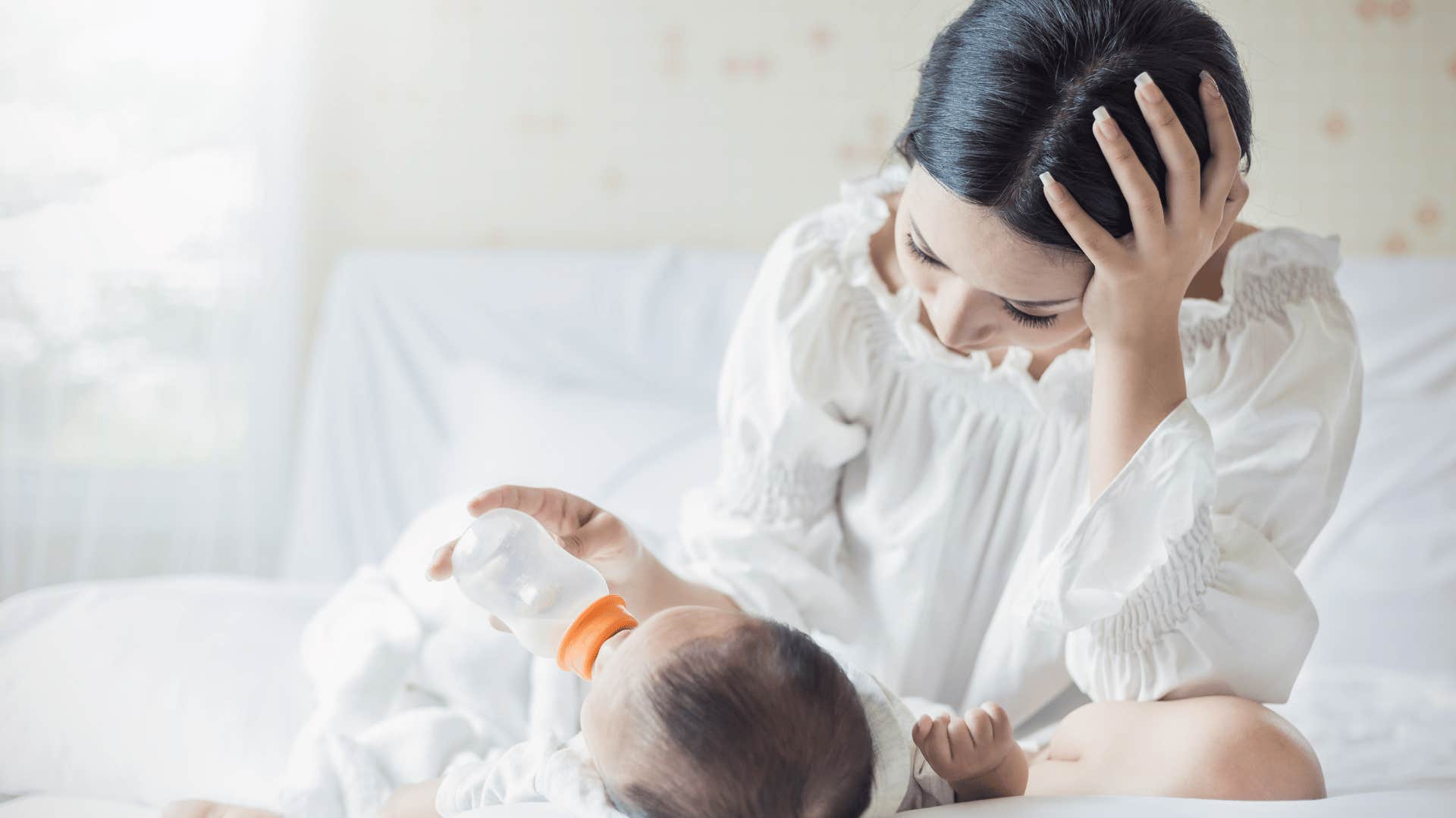 anxious mother feeding baby