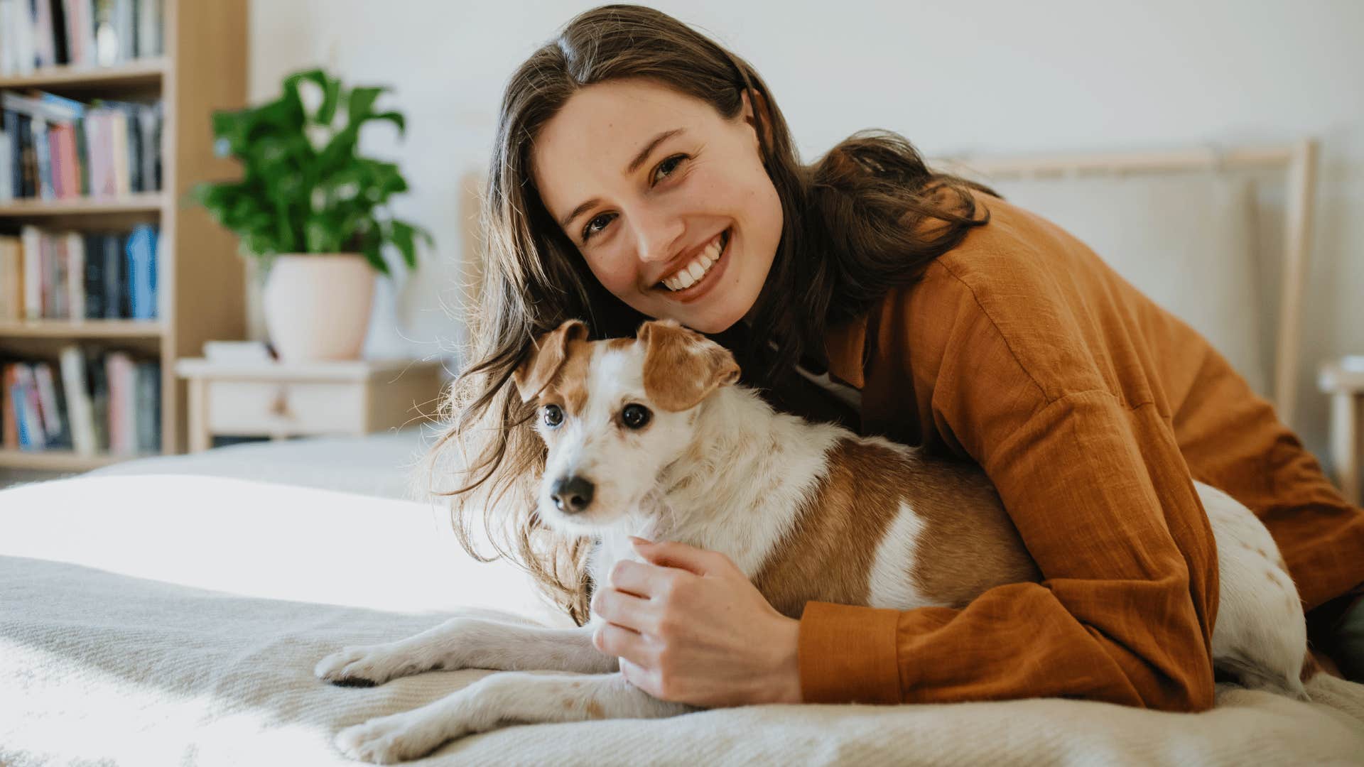 woman providing her dog with comfort and safety