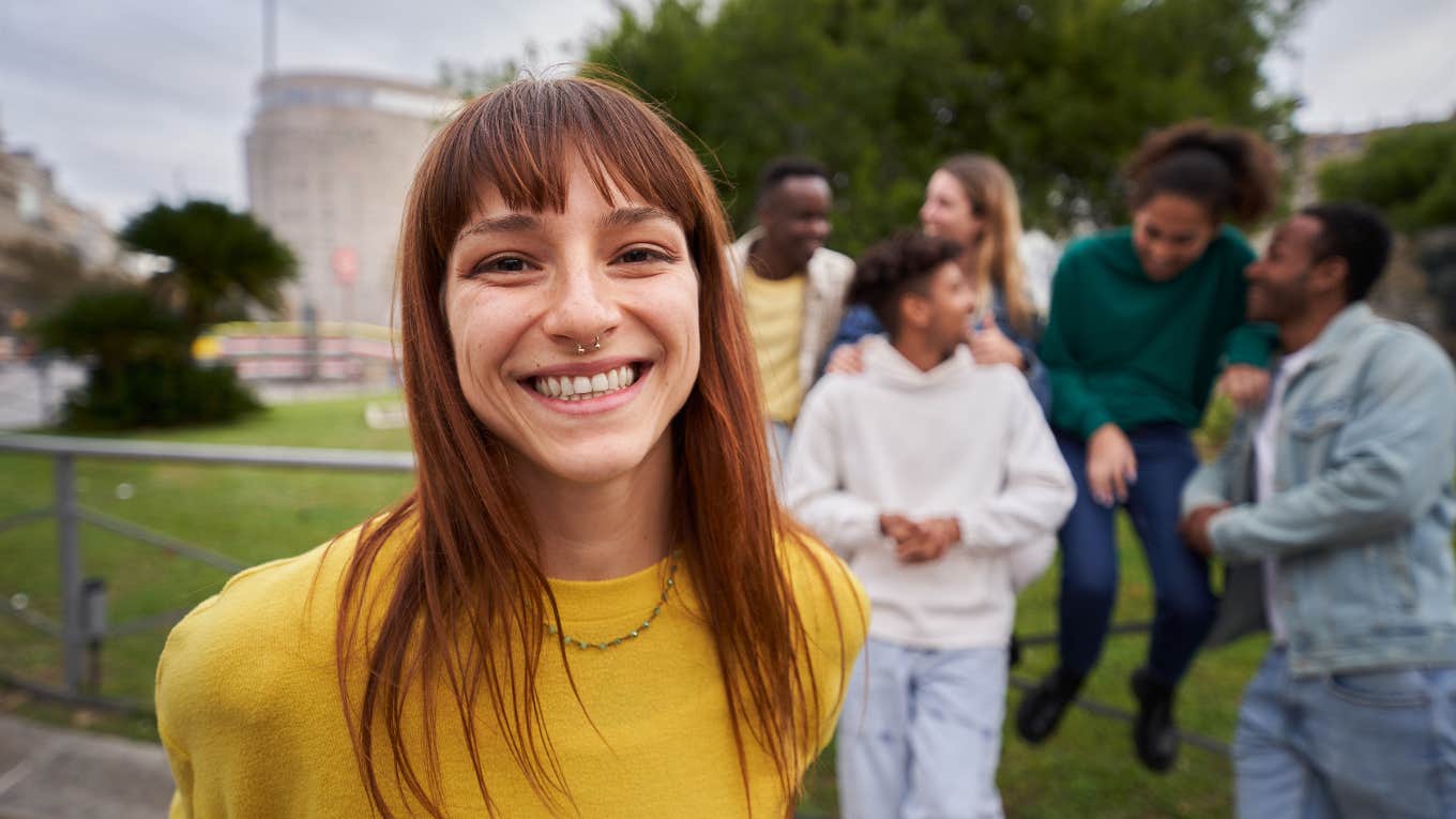 likable young red-haired girl with wide smile and piercing look