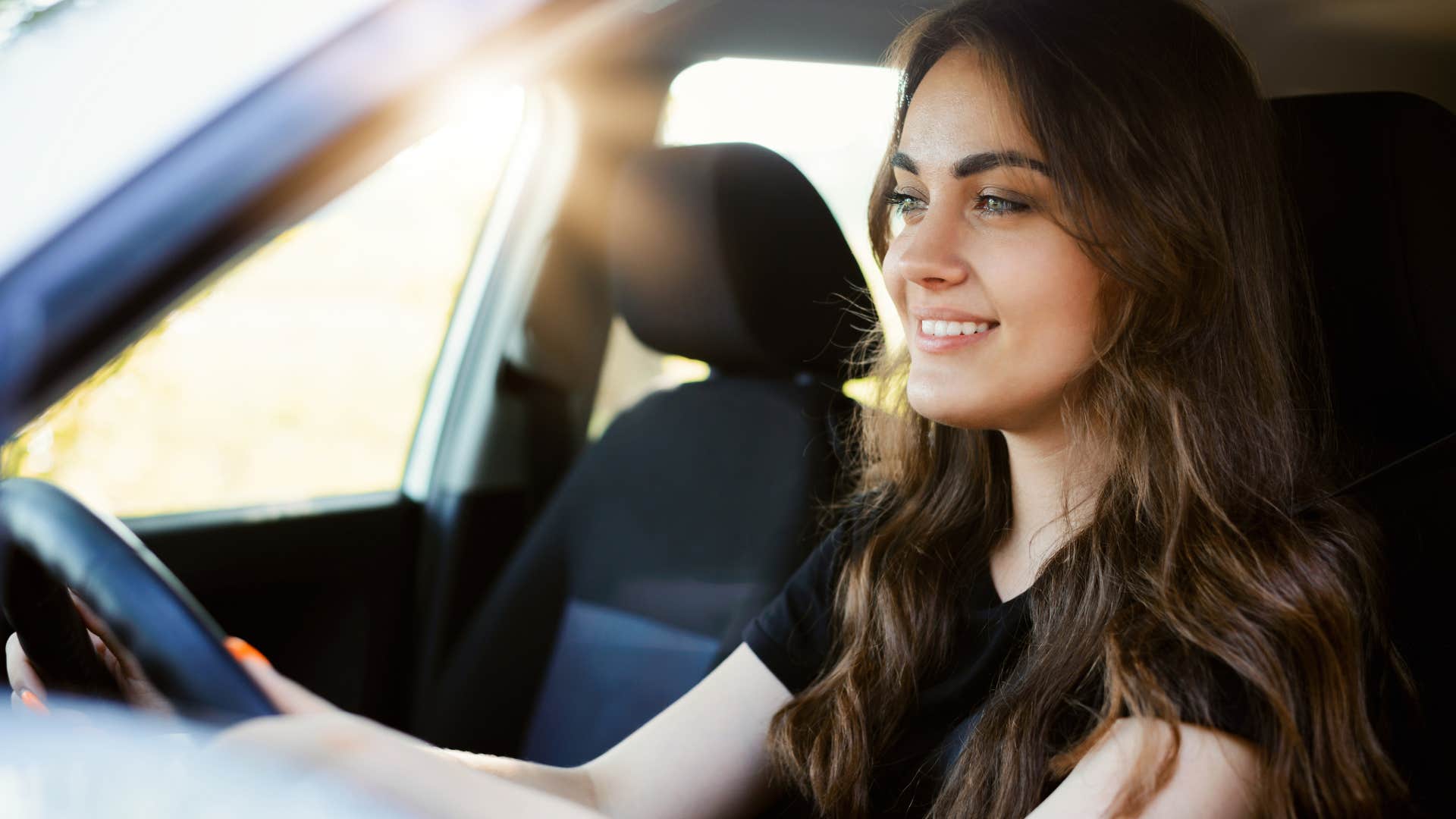 Young woman learning to drive a car