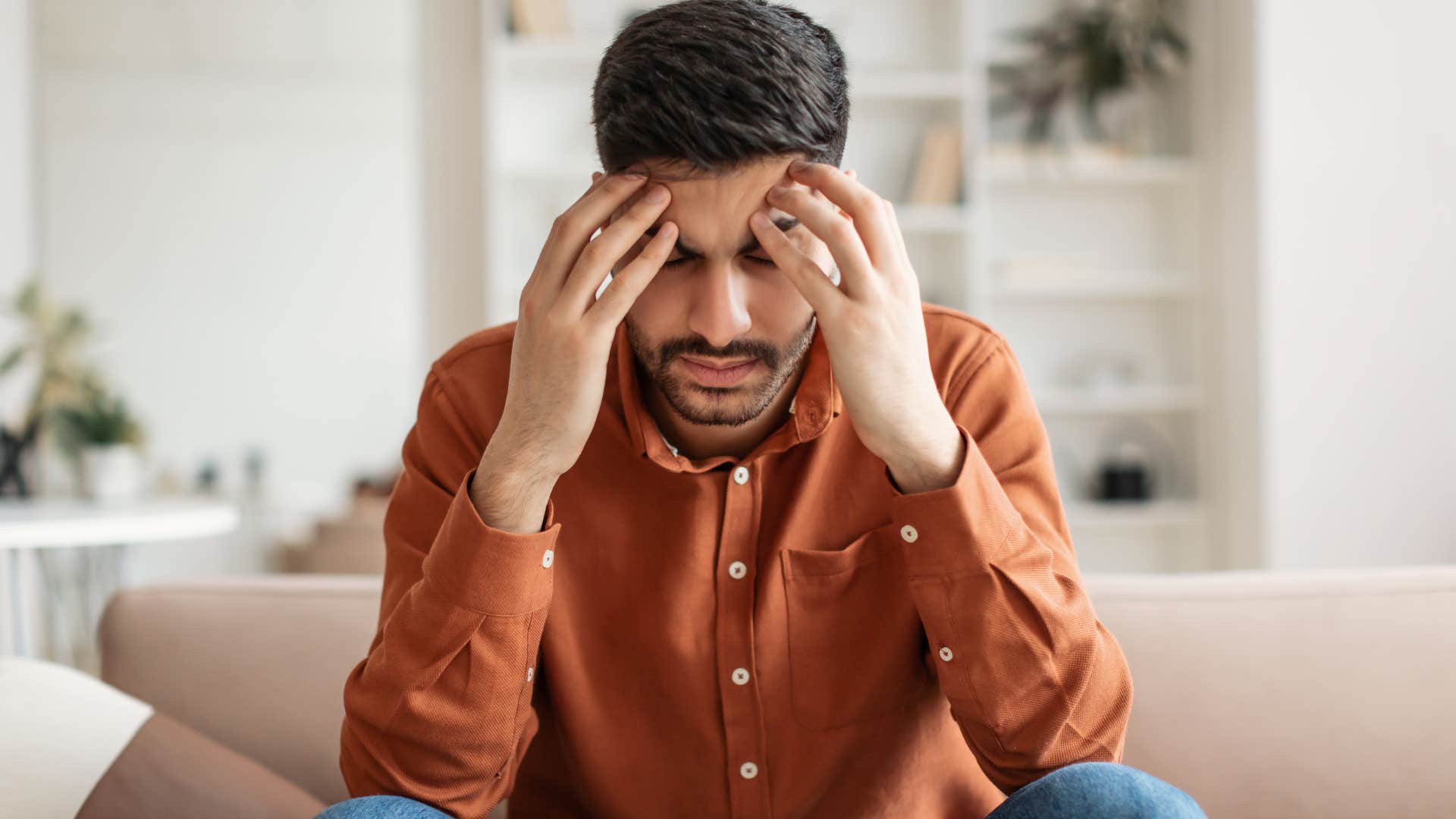 Gen Z man holding his head trying to do mental math