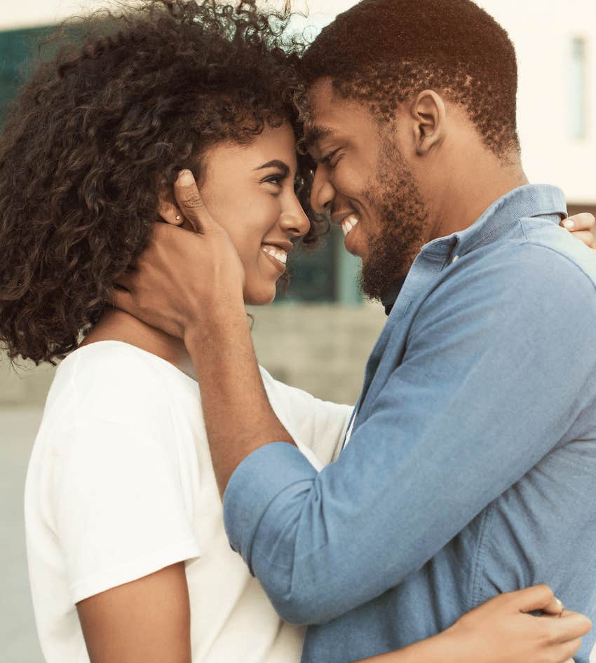 Thankful man embraces smiling woman