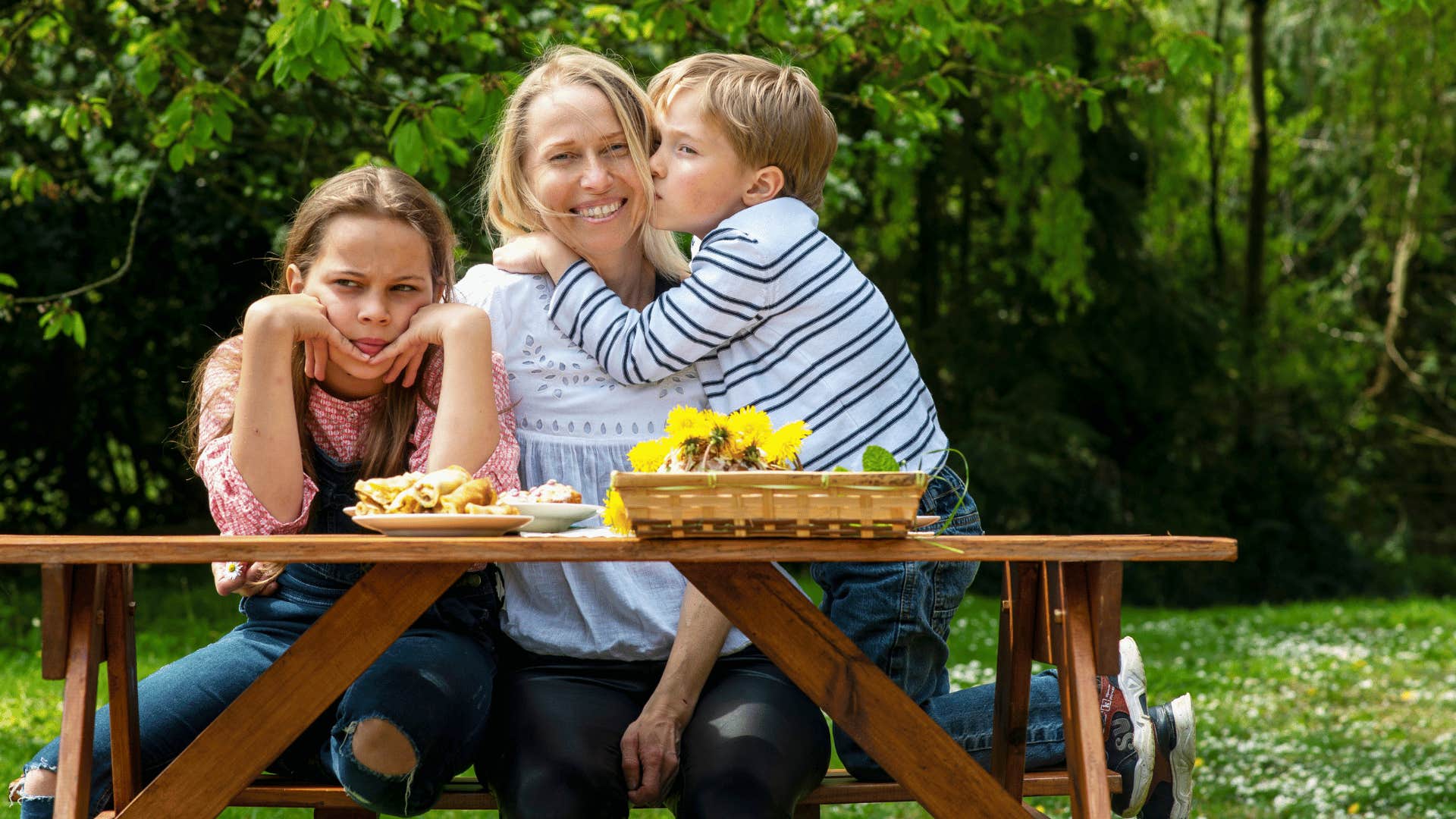 mother with son and daughter at picnic table