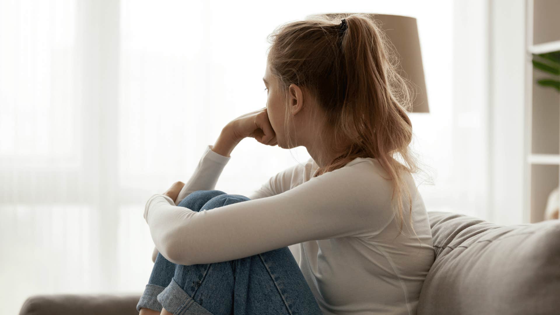 upset woman sitting on couch