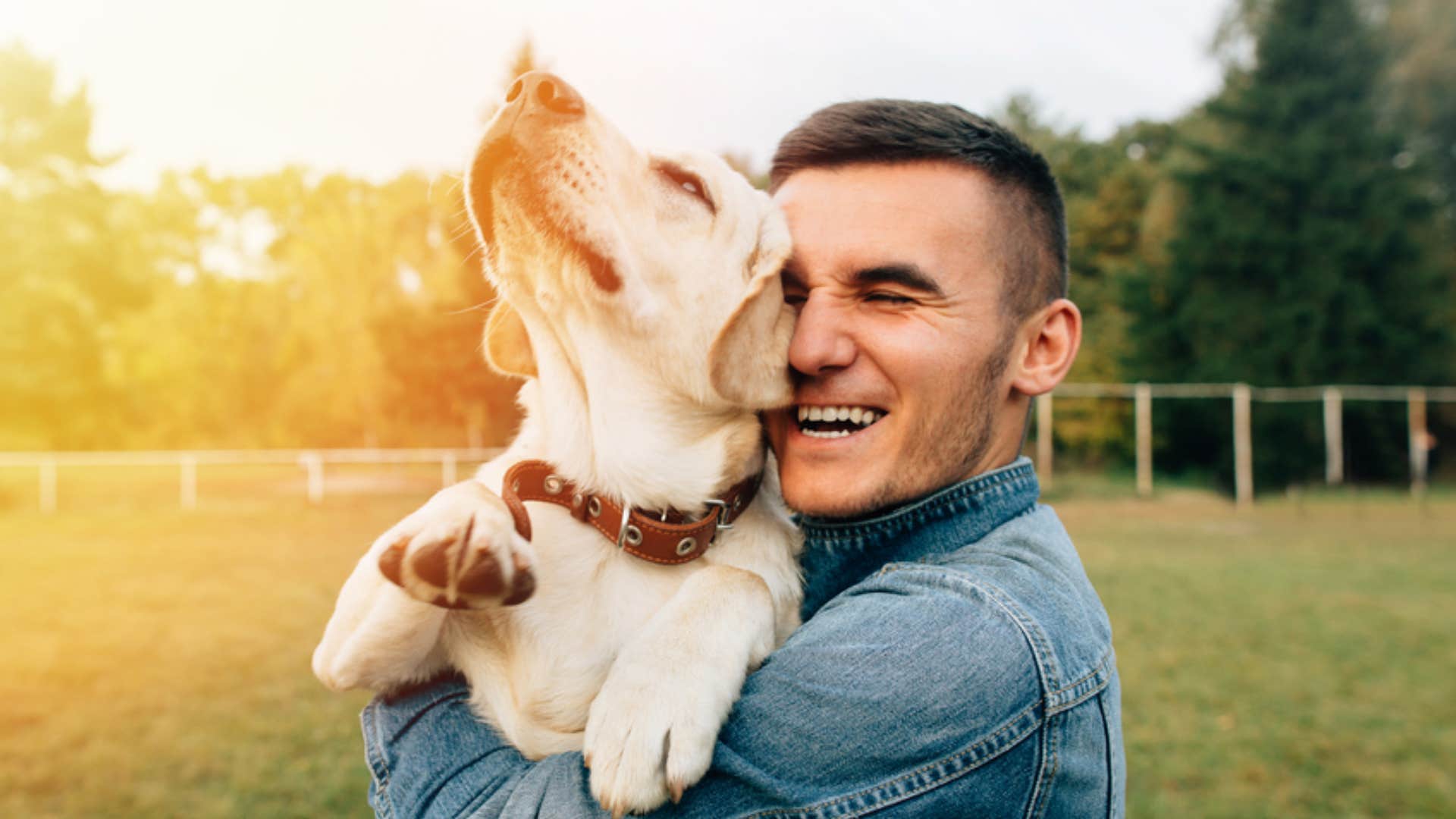 man hugging his pet