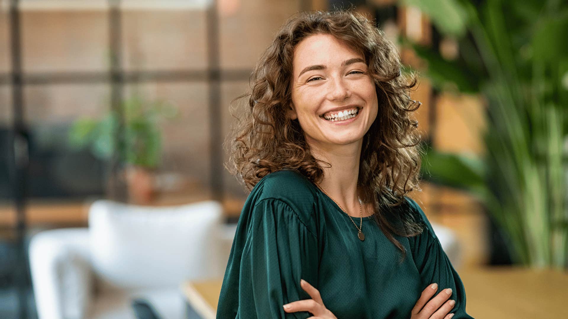 smiling woman with her arms crossed