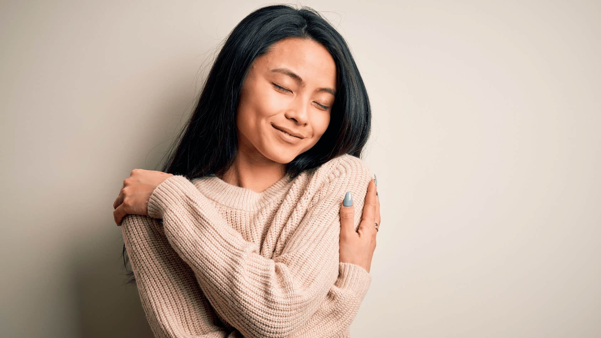 woman hugging herself