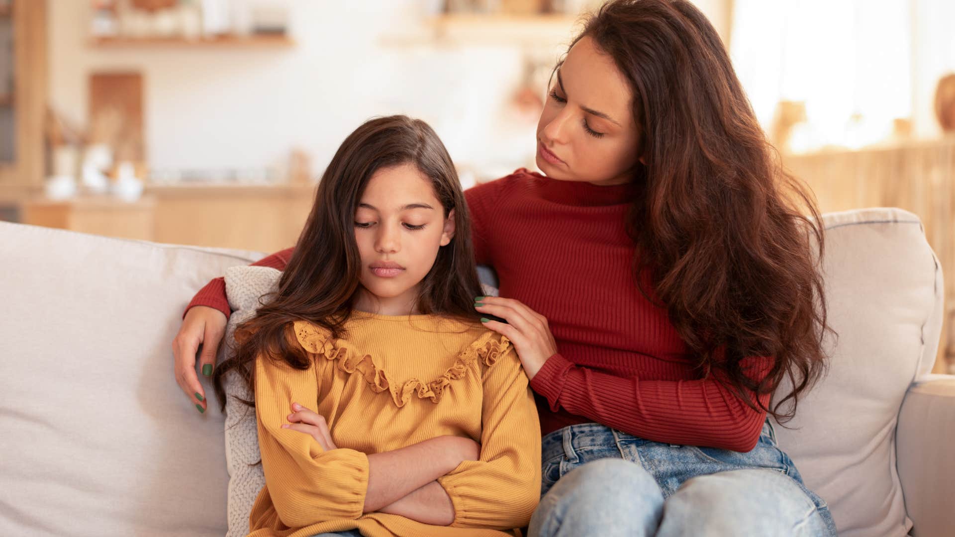 Woman comforting her angry teenage daughter