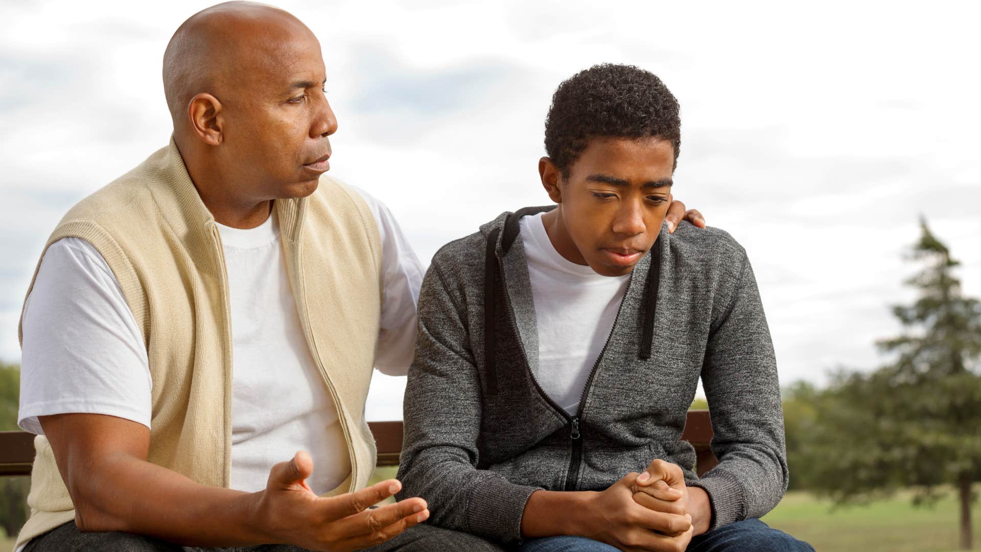 Dad having a serious conversation about sticking to commitments with his teenage son