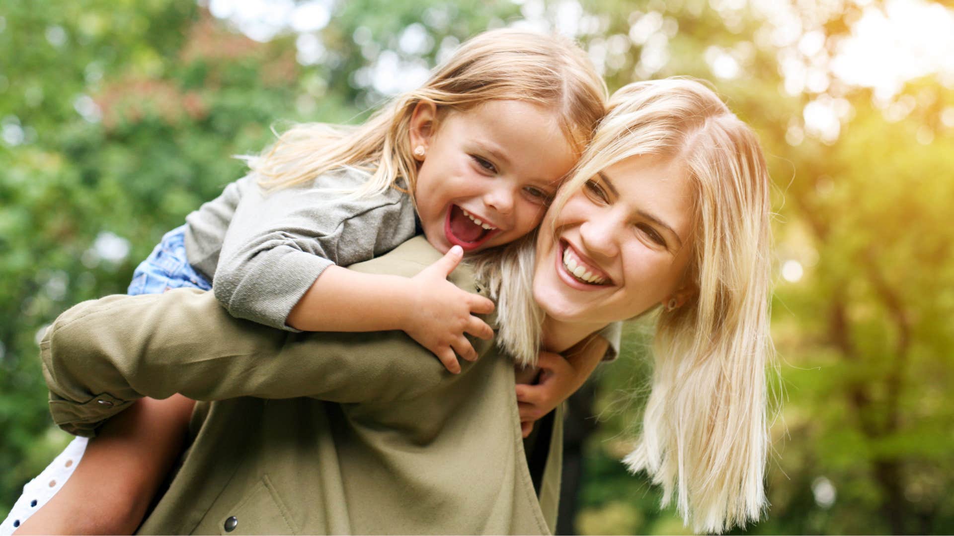 Woman smiling and holding her daughter while being grateful for small things