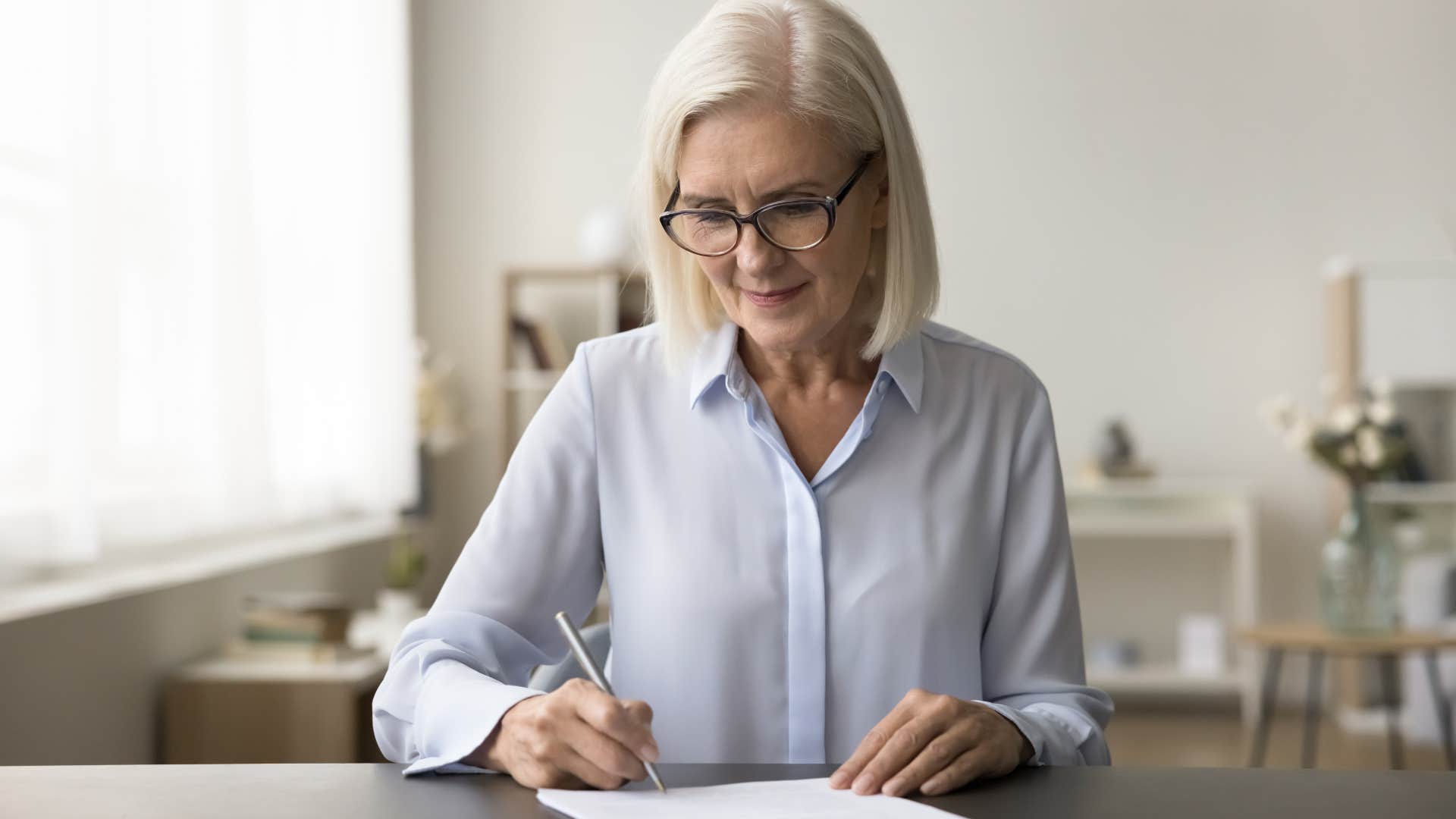 Older woman writing letters