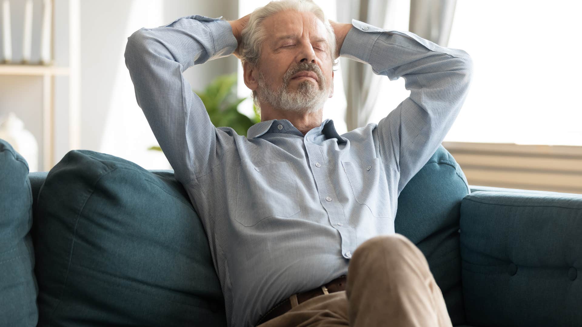 Older man napping on his couch