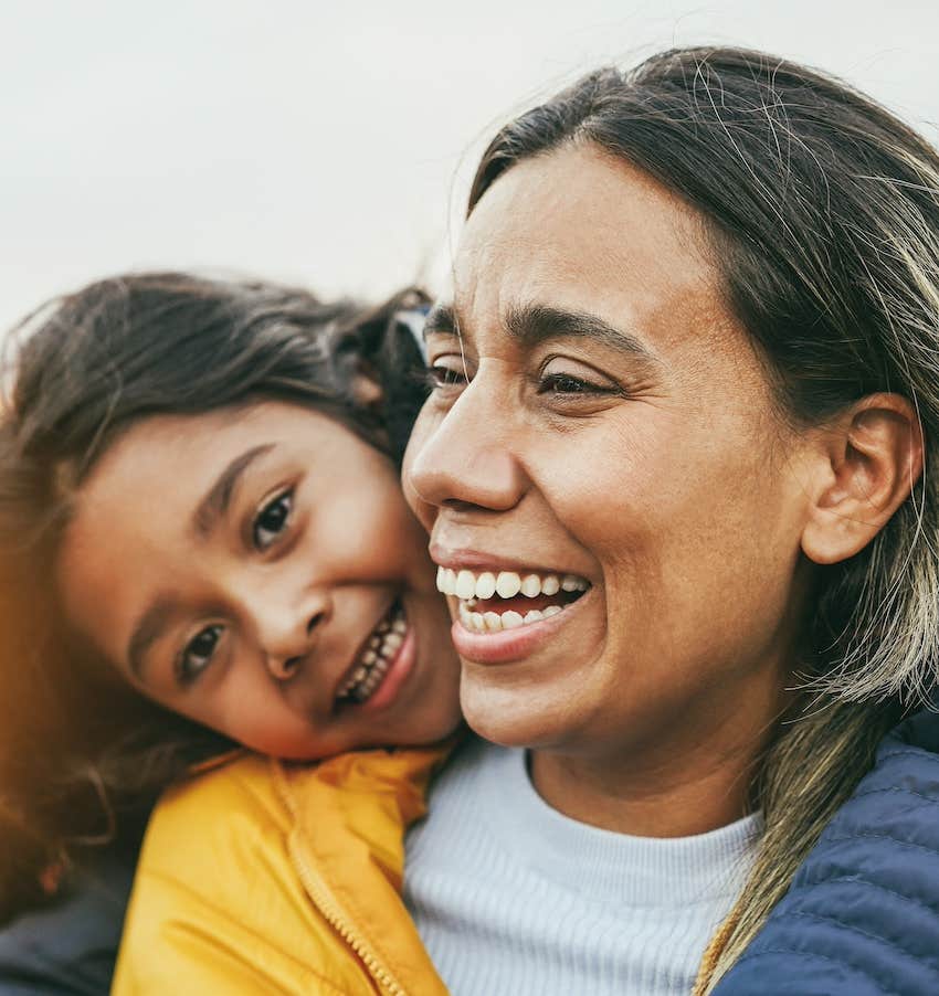 Mother and child laugh and hug