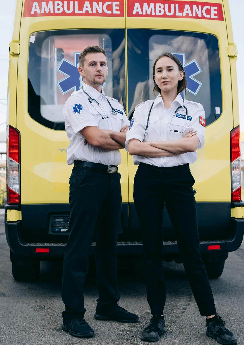 paramedics standing outside of back of ambulance