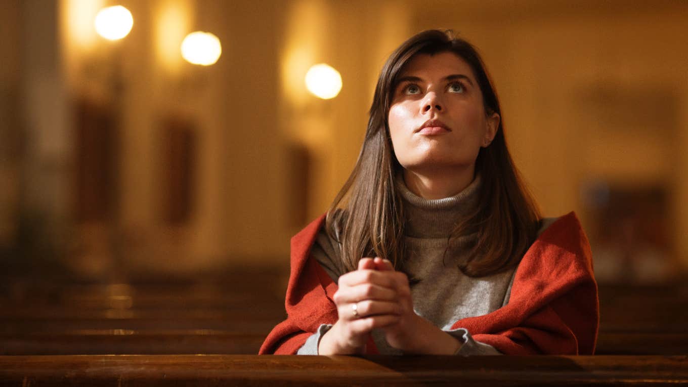 Parent sitting in the aisle seat of a church pew