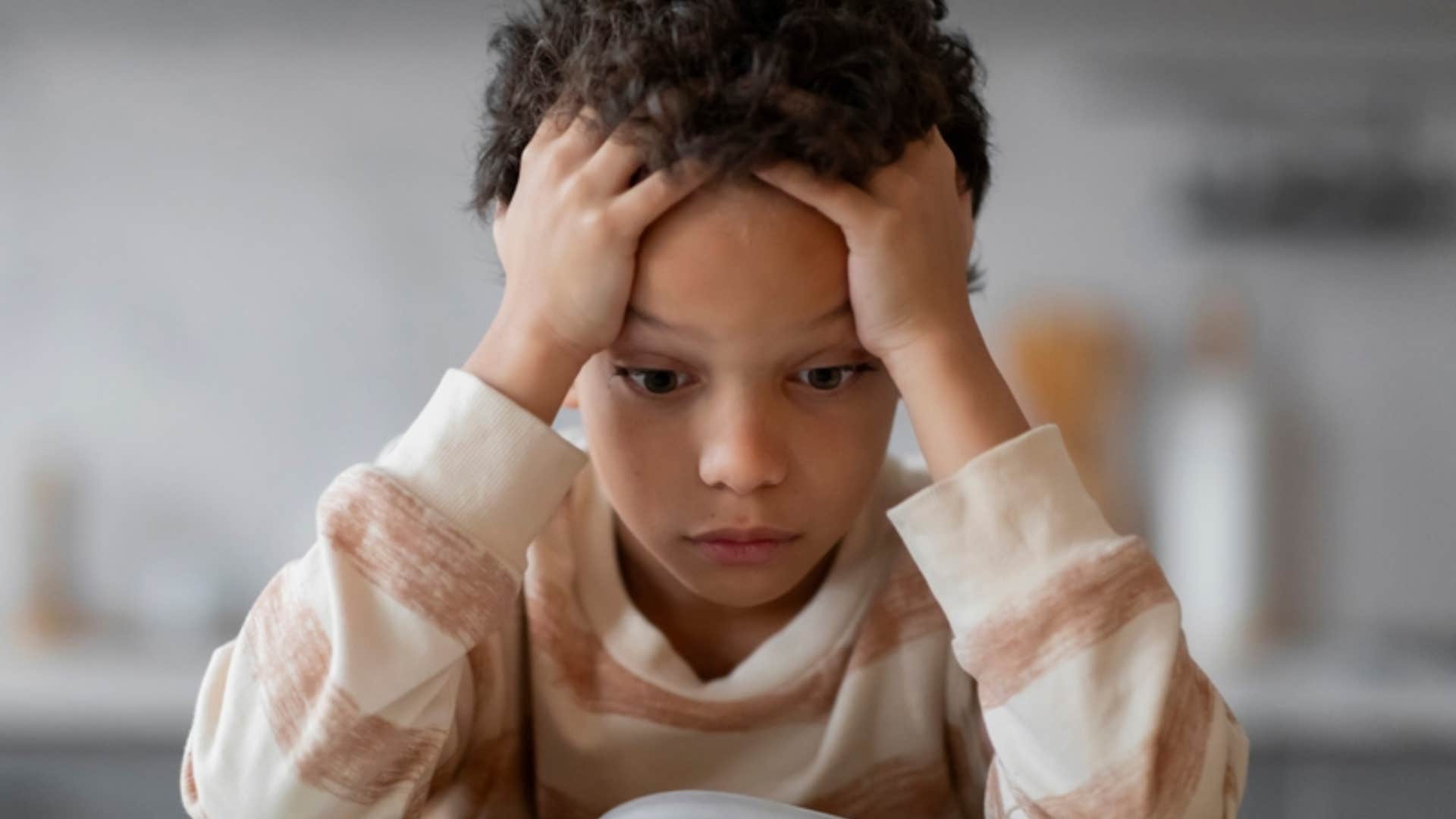 stressed little boy feeling overwhelmed