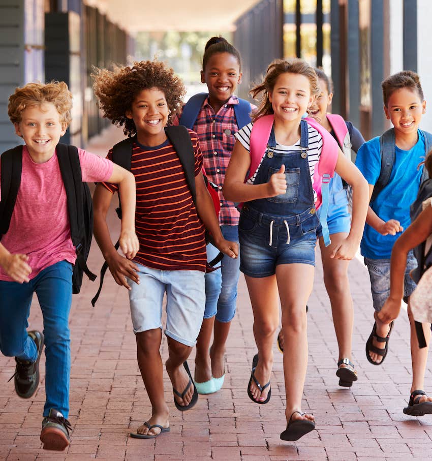 School children run and laugh