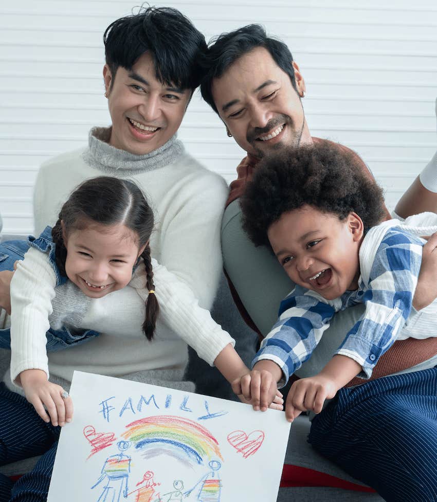 Parents with happy children displaying their drawing