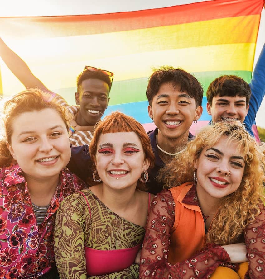 Group of teenagers holding rainbow flag