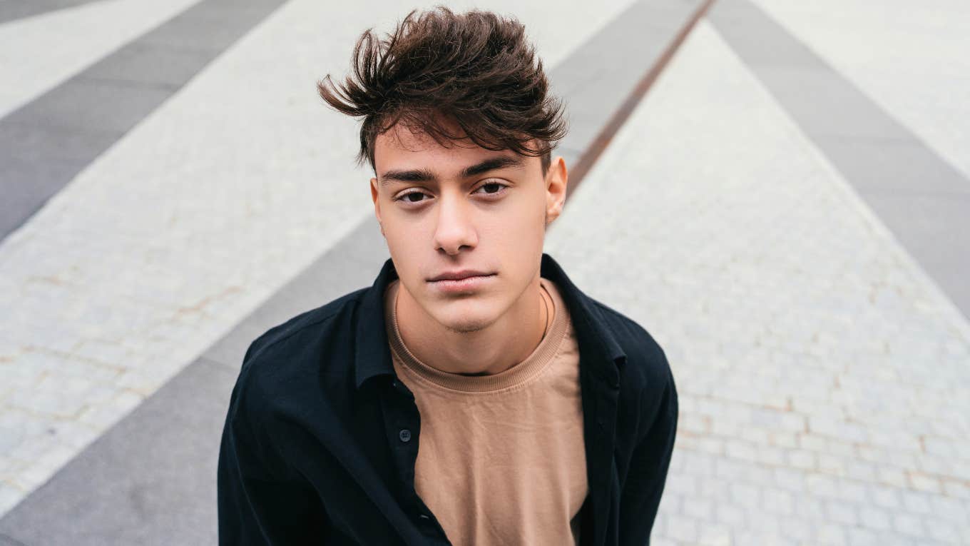 Anxious young man looking at camera thinking about his parents' mistakes