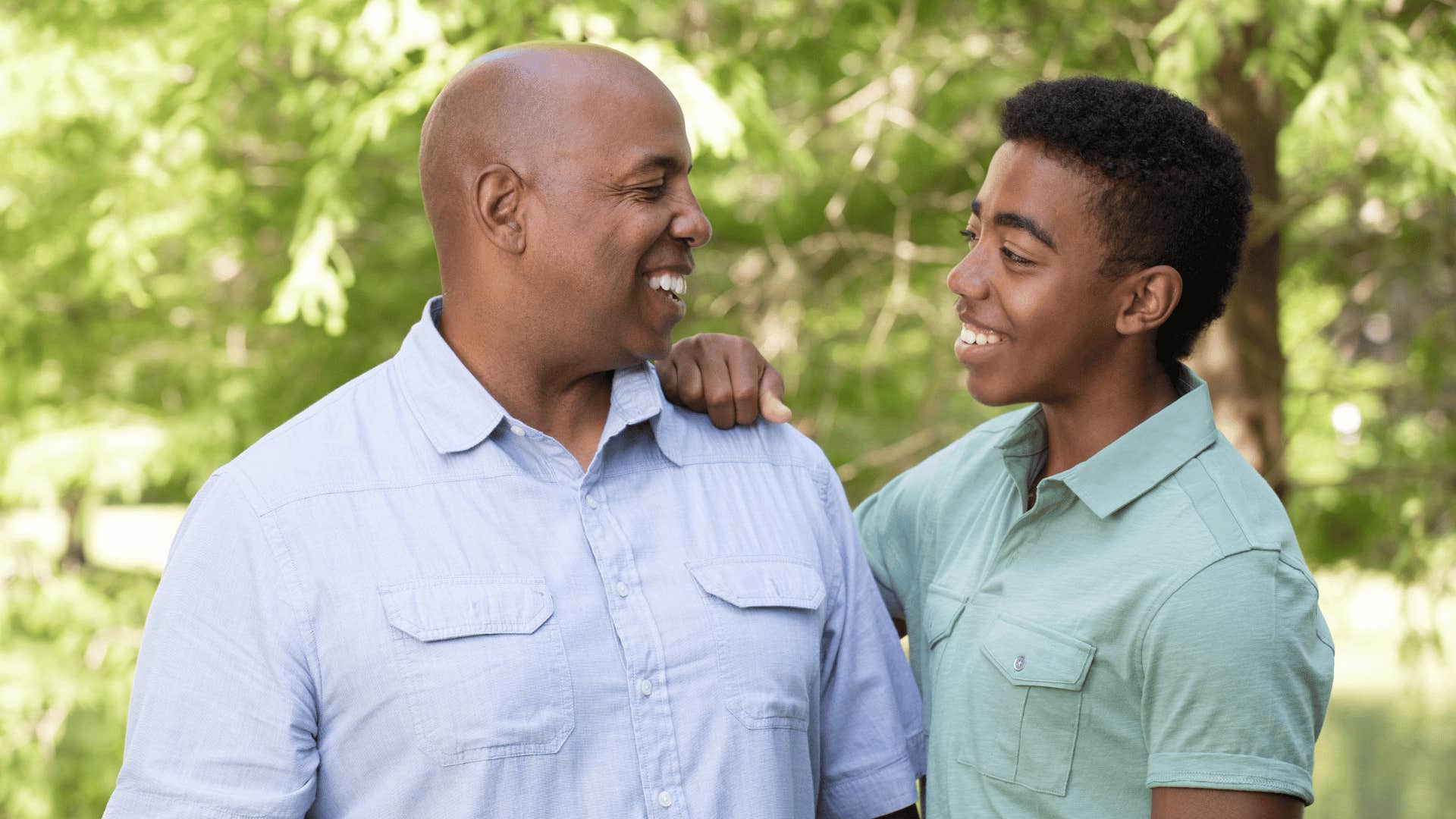 Father smiles with teenage son who doesn't need to be controlled