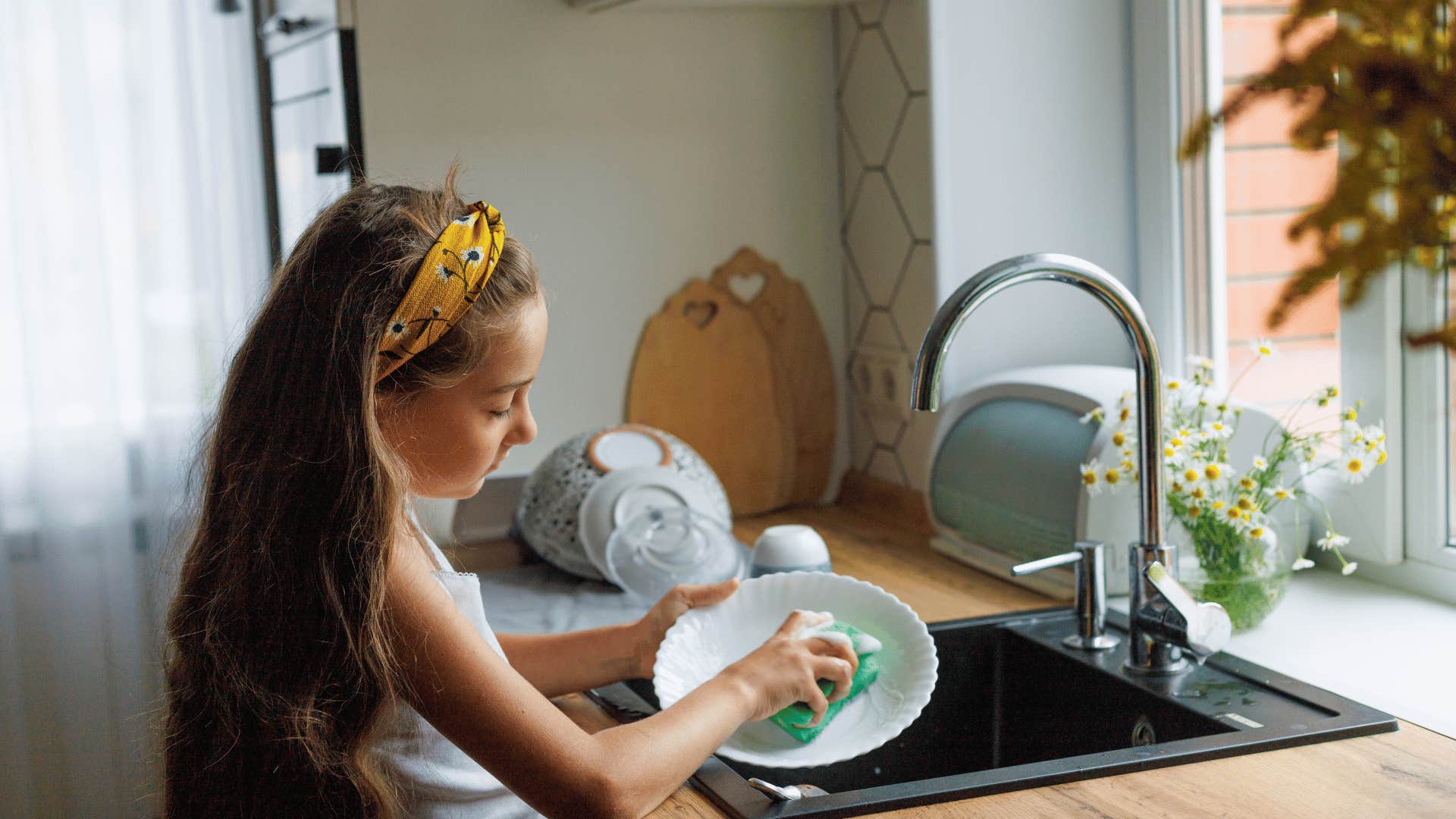 child washing dishes