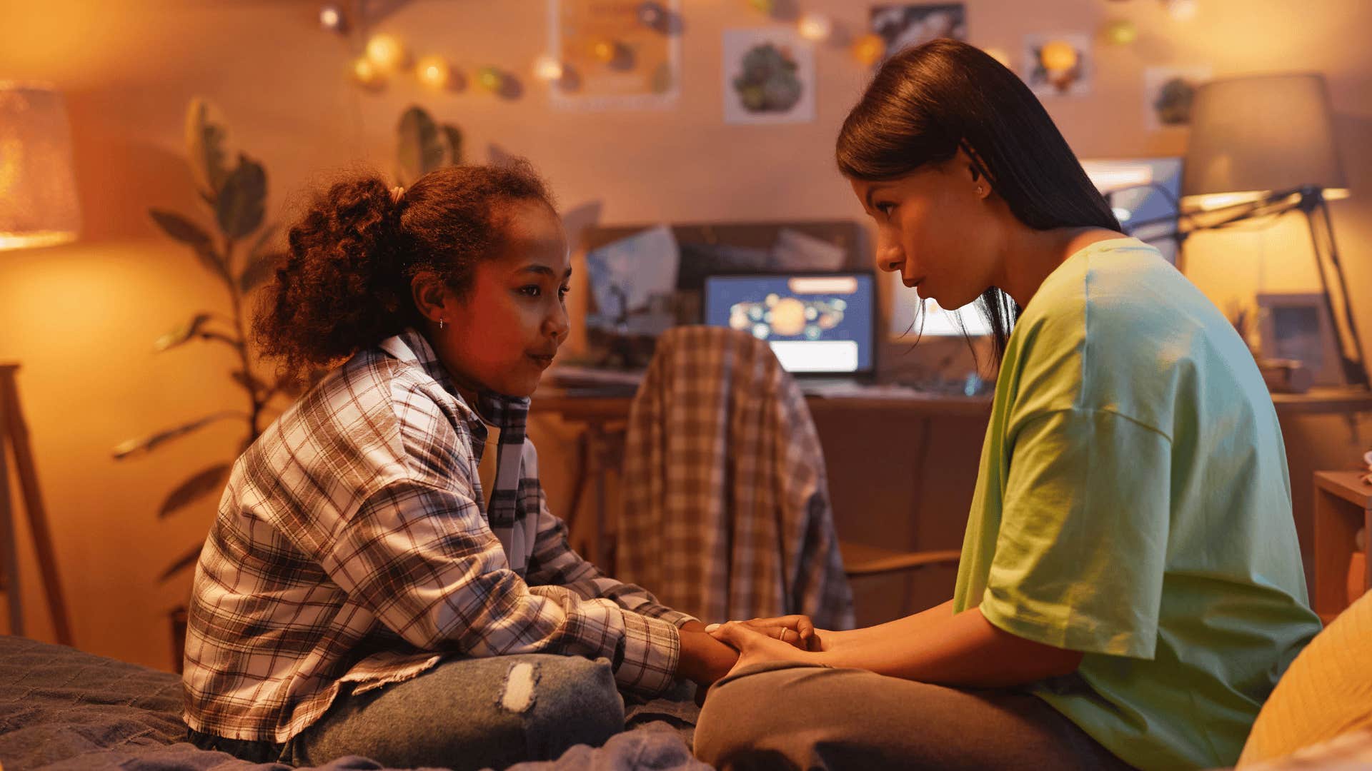 mother talking to daughter in bedroom