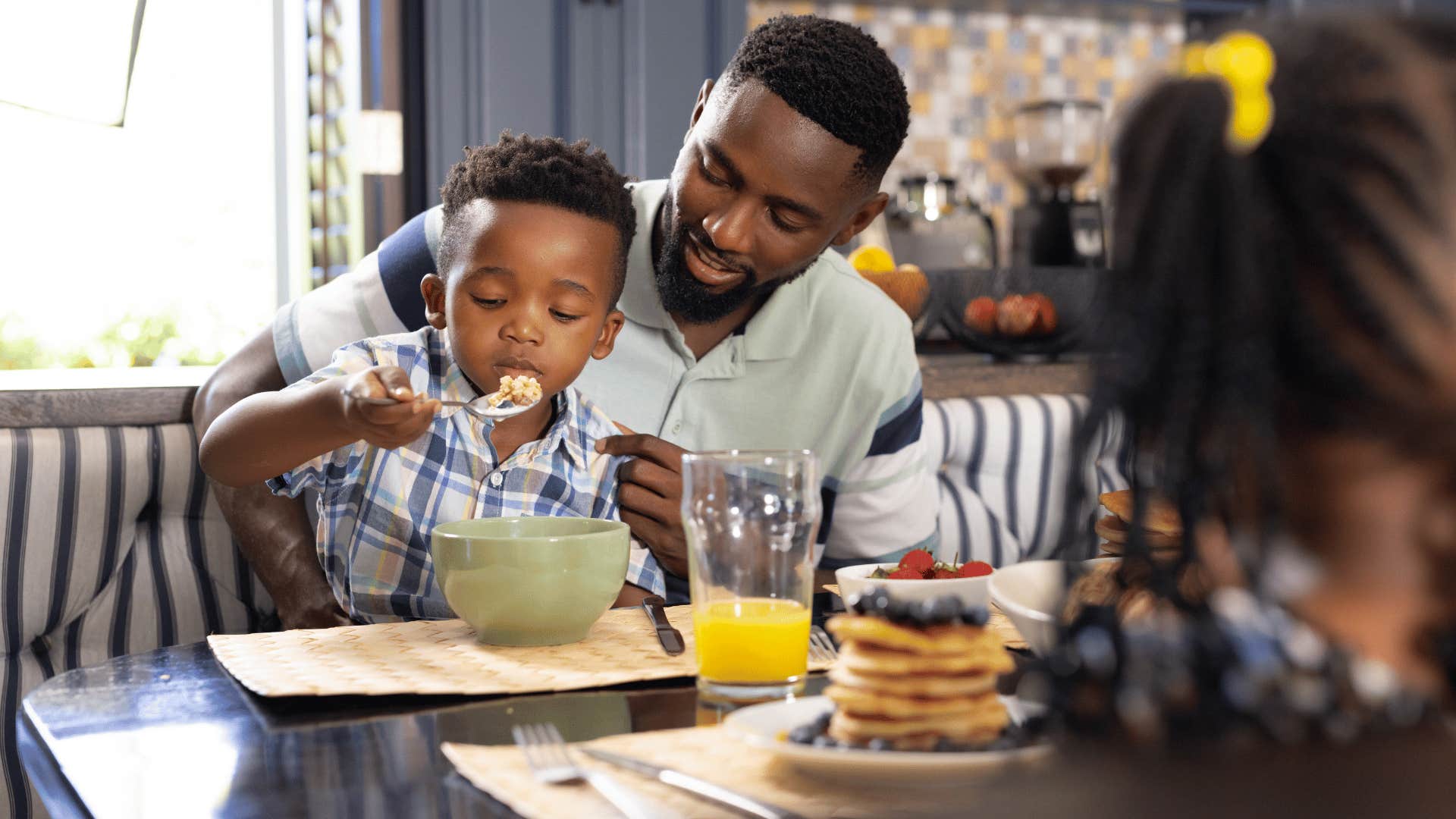 father eating breakfast with son