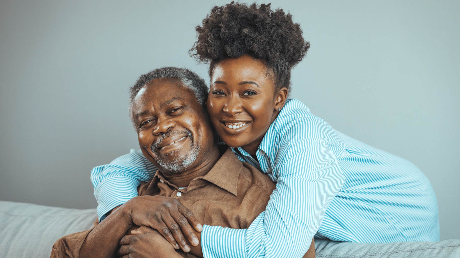 daughter hugging father from behind enjoying the present moment