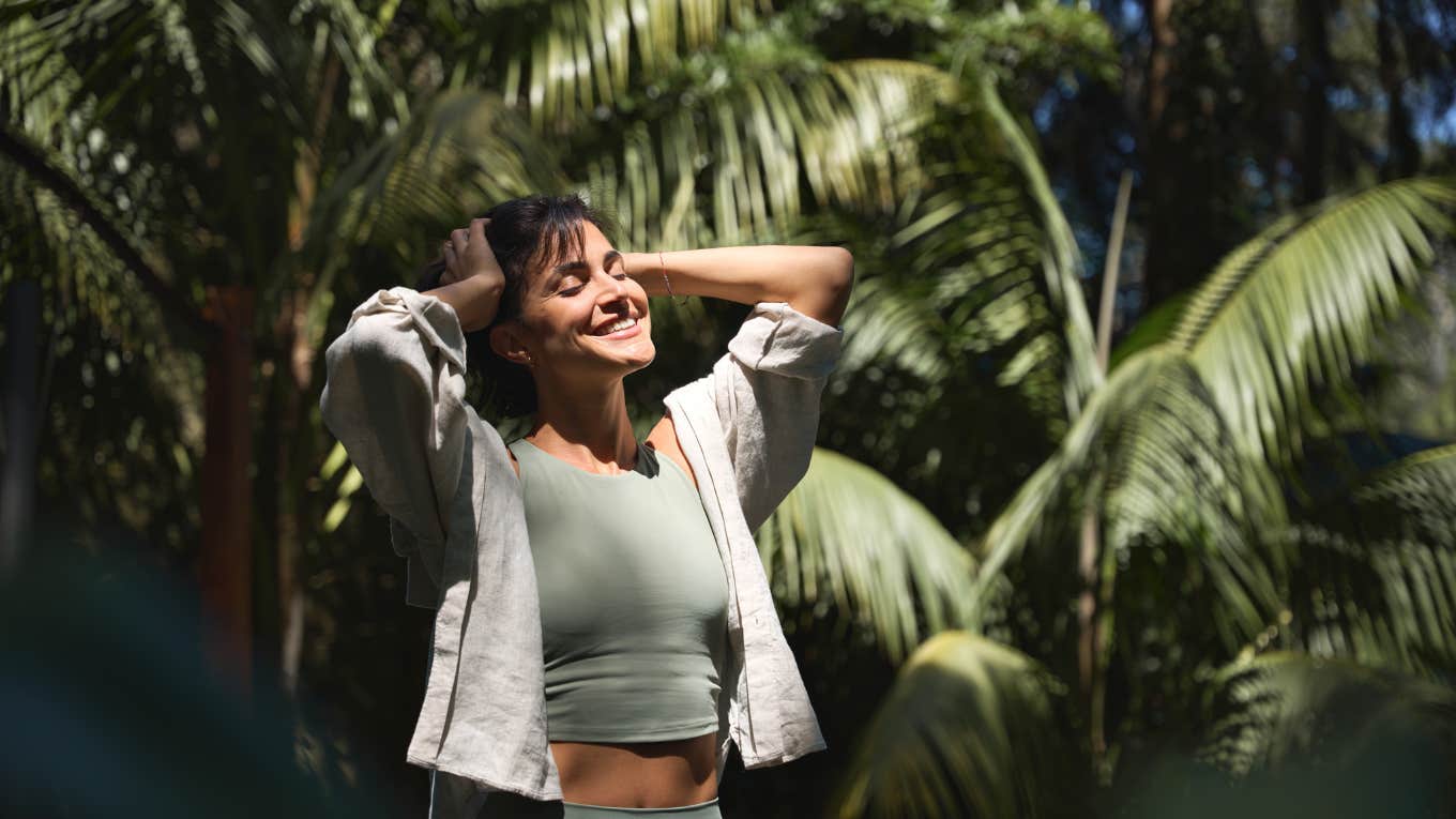 chill woman enjoying summer sunny day with eyes closed 