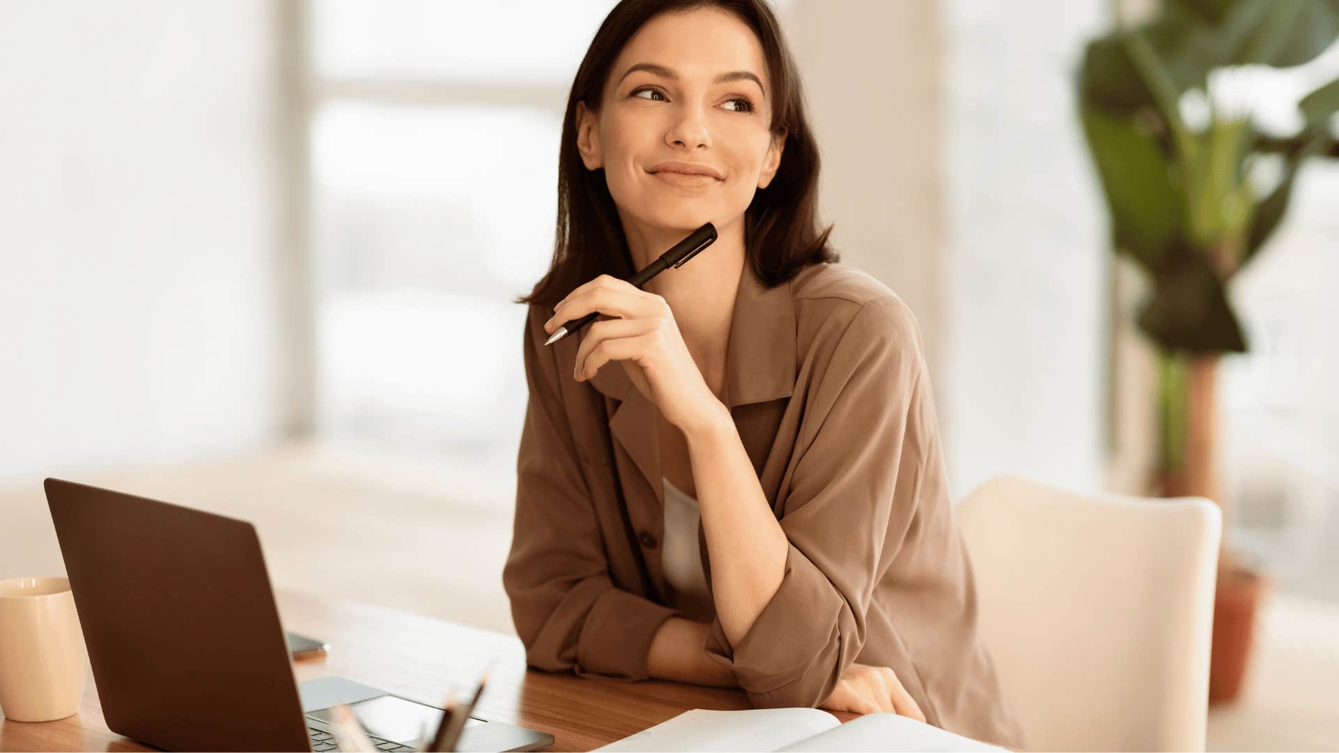 woman smiling in front of laptop