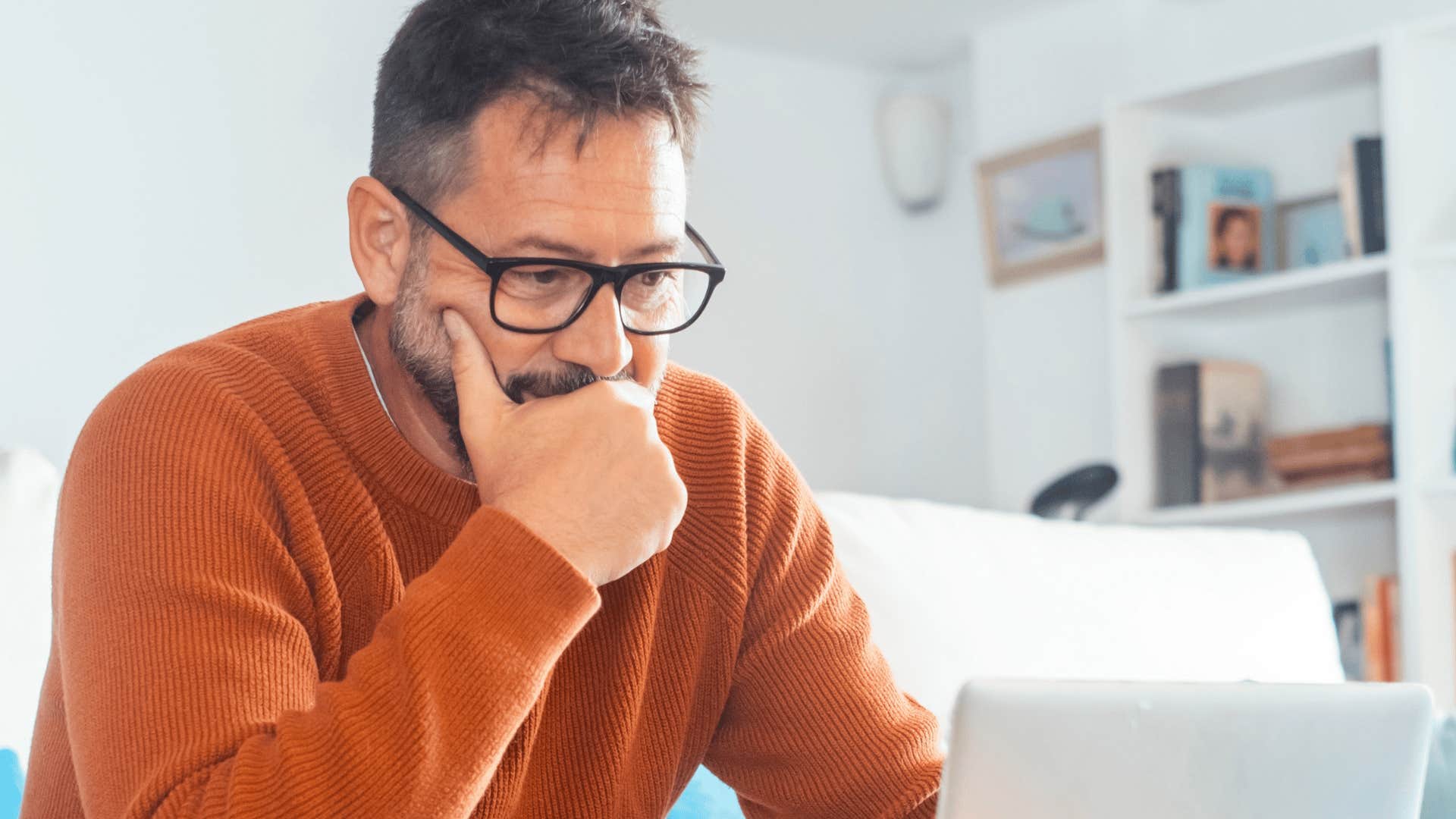 man sitting working on laptop