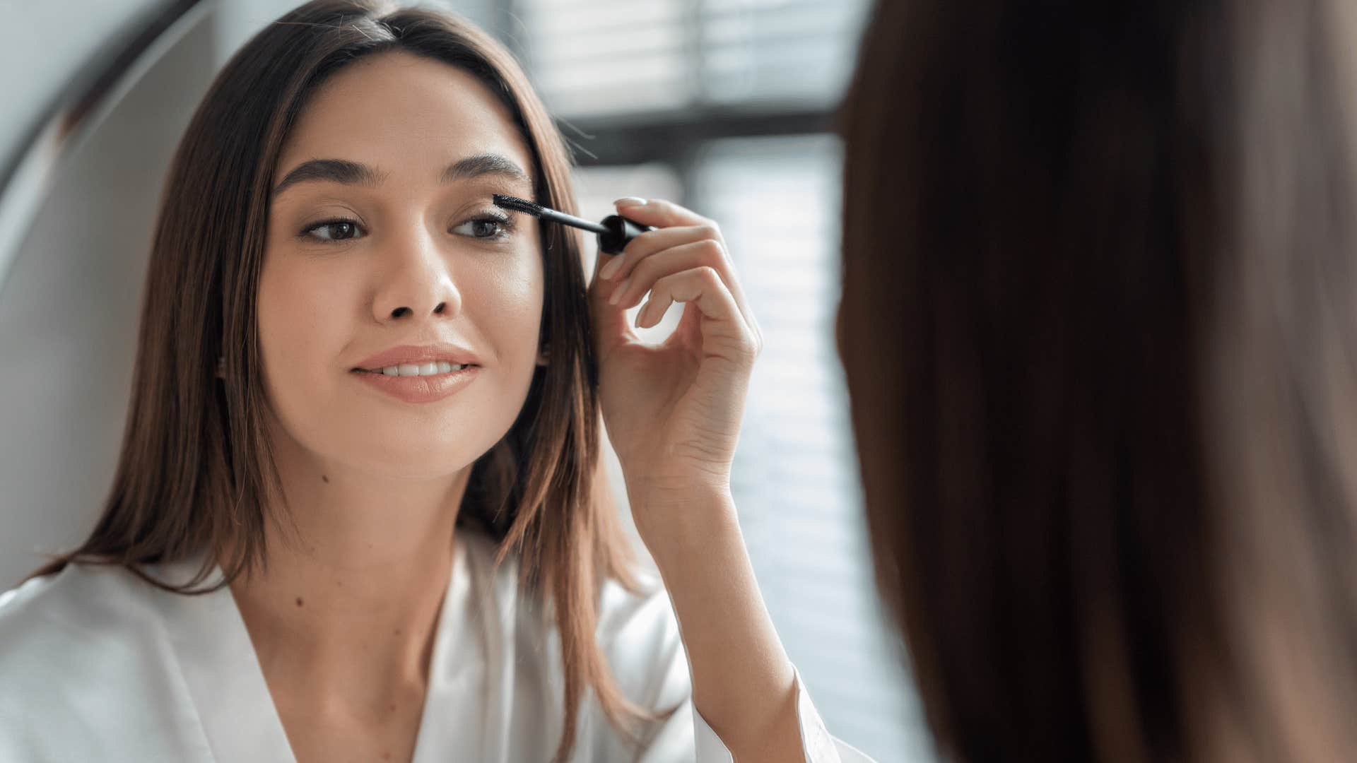 woman putting on makeup